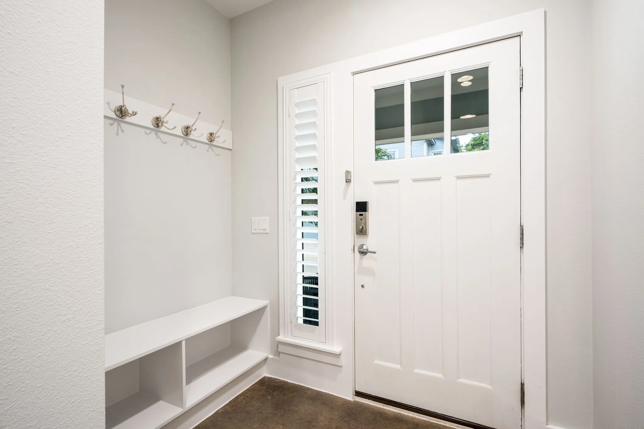     Thoughtfully designed mudroom entry with built-in storage and smart lock access.