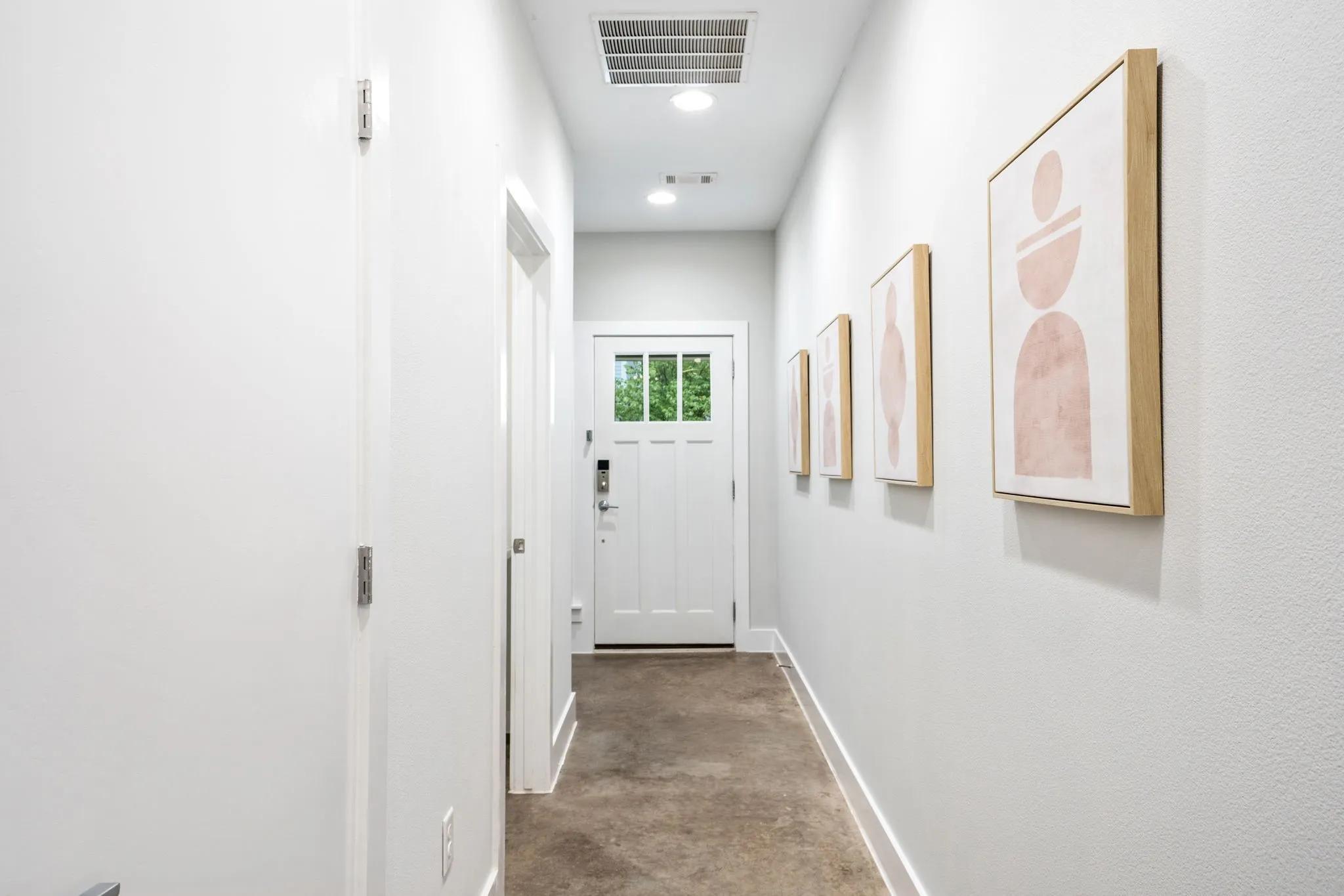     Welcoming entry hallway with gallery-style walls and contemporary finishes throughout.