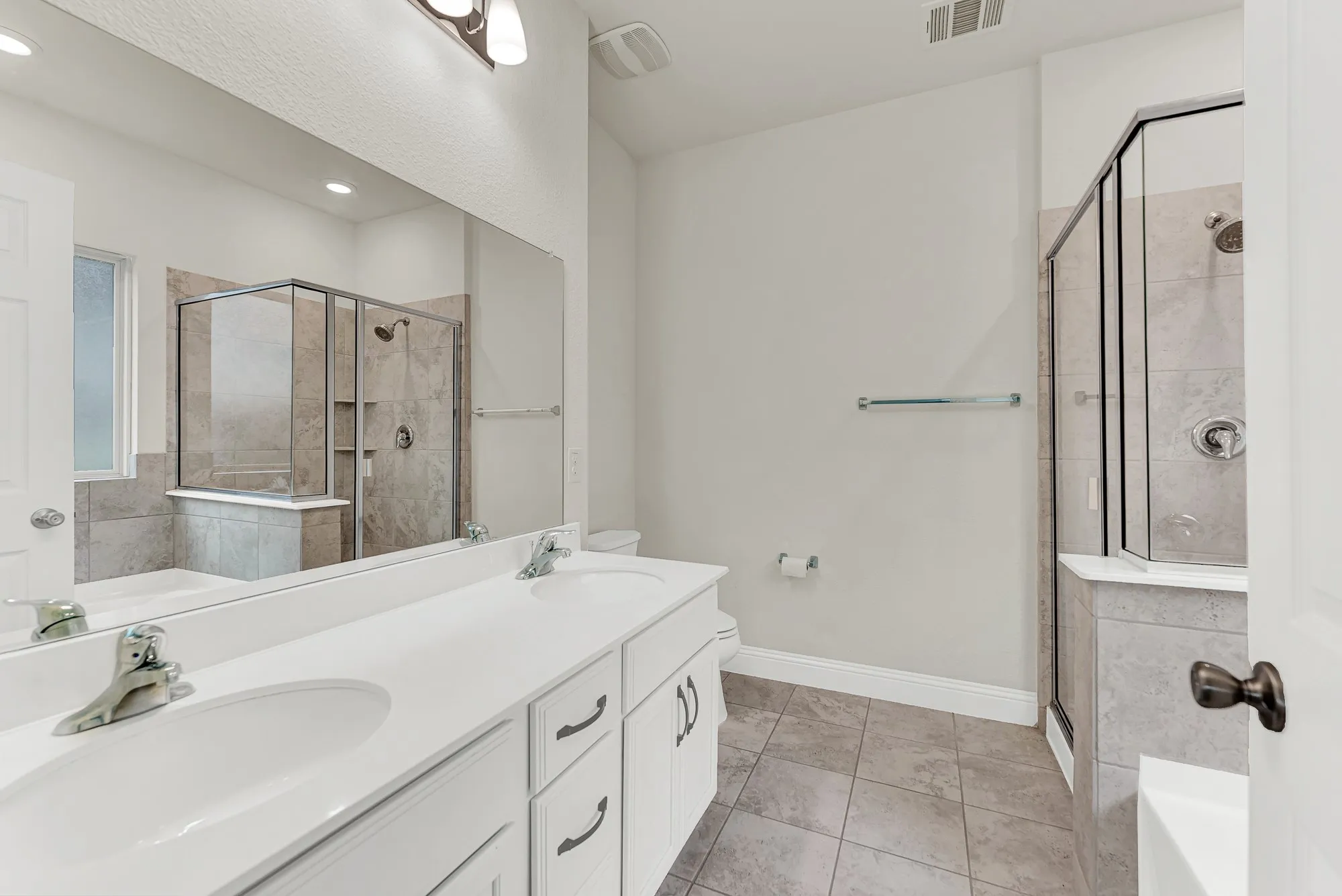 A full-width mirror doubles the visual depth, highlighting the clean, white cabinetry and functional, modern lines. This bright space transforms your daily routine into a calm, ritualistic experience, helping you face the day with clarity