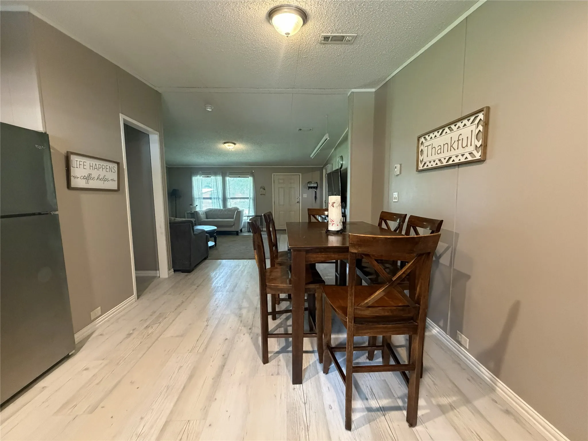 Light wood-finish flooring extending into the main living space
