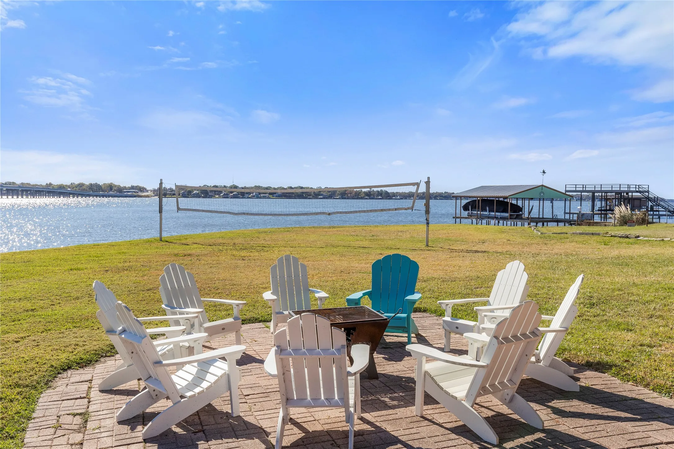 Fire pit looking over lake and volleyball court