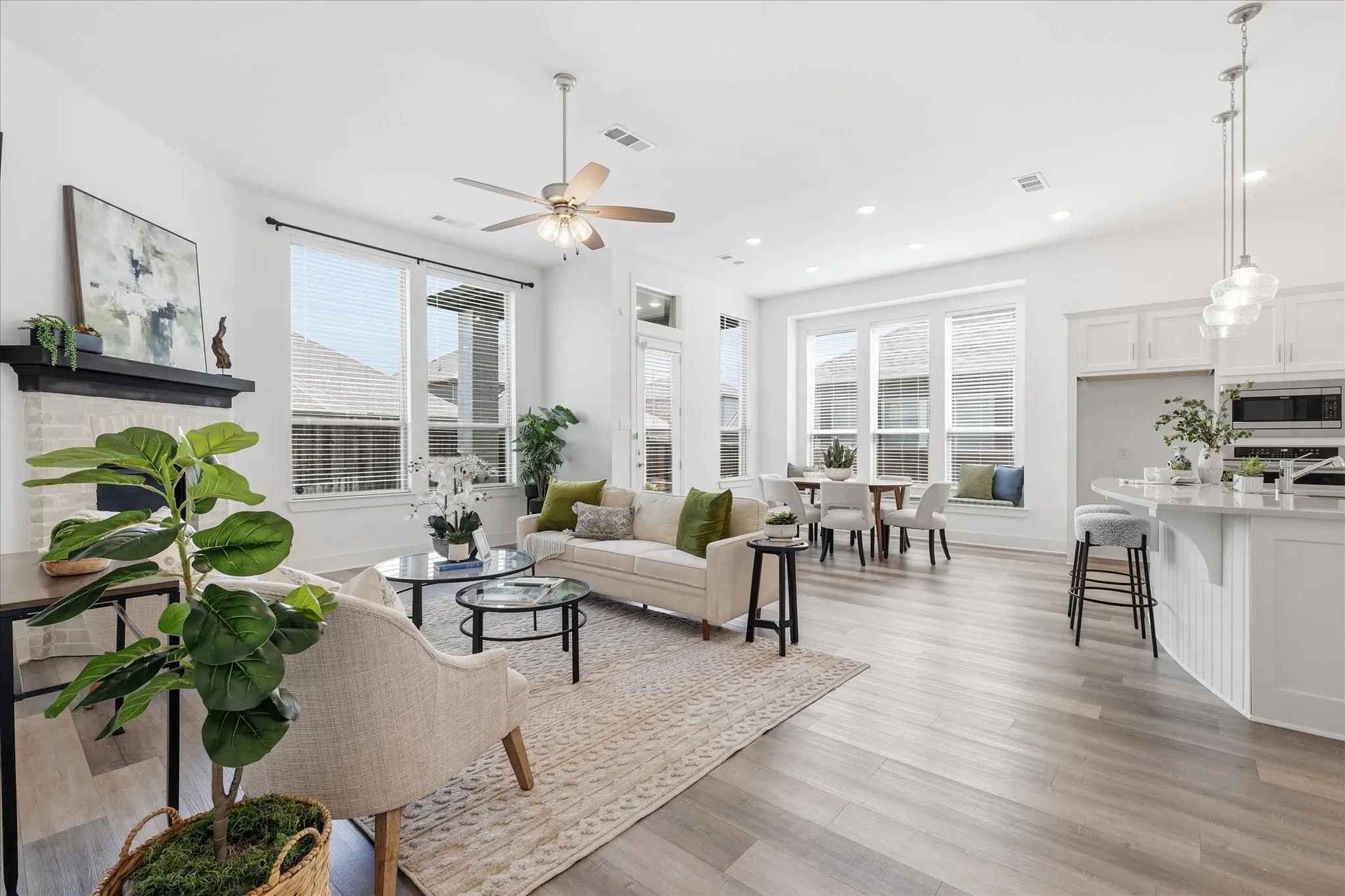 Living area with Luxury Vinyl flooring, natural light galore, gas fireplace and more!