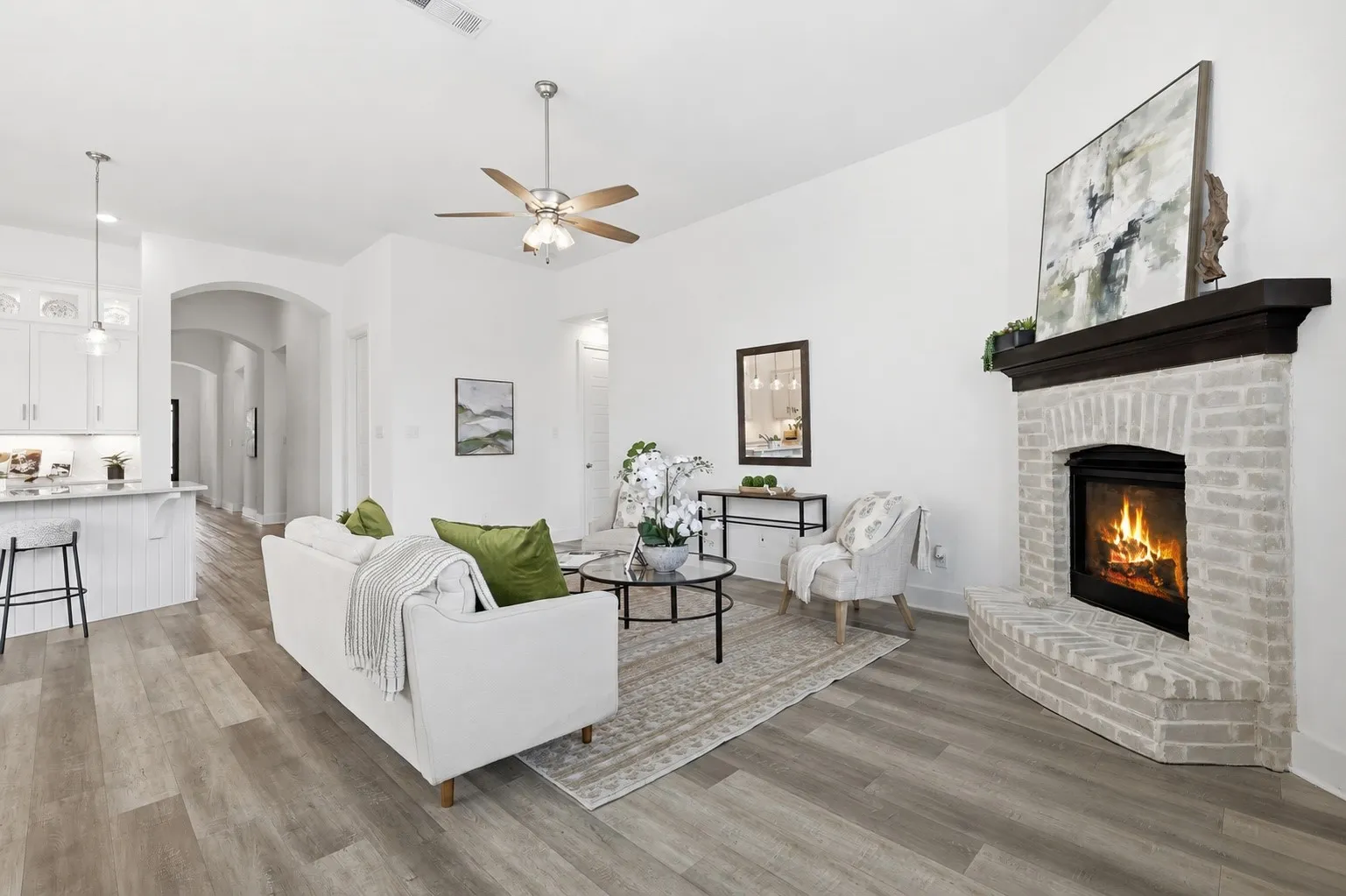 Living area with Luxury Vinyl flooring, natural light galore, gas fireplace and more!