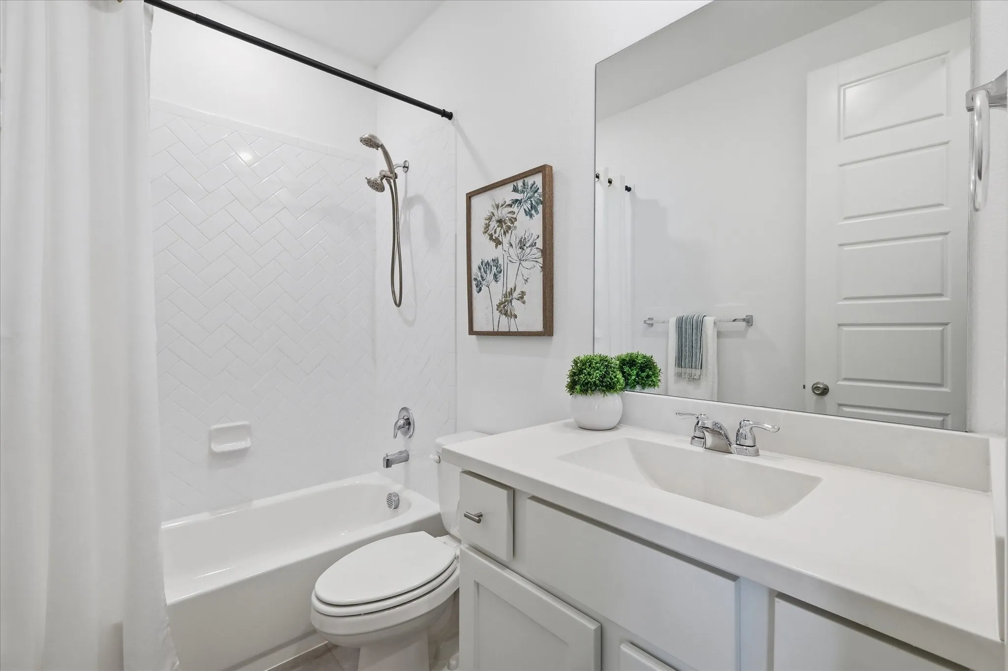 Private split bathroom off the hall with shower tub combo.