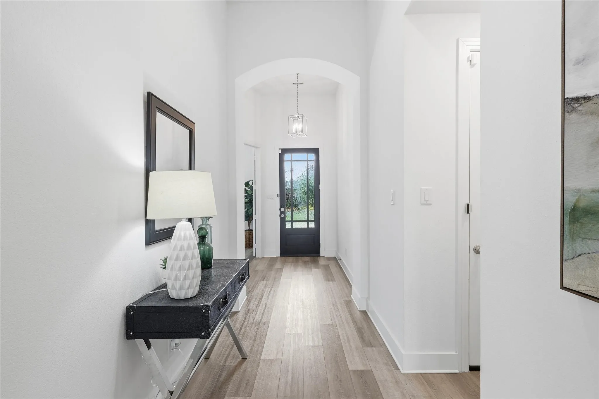 Gorgeous foyer with high ceilings, Luxury Vinyl Flooring and freshly panted walls!