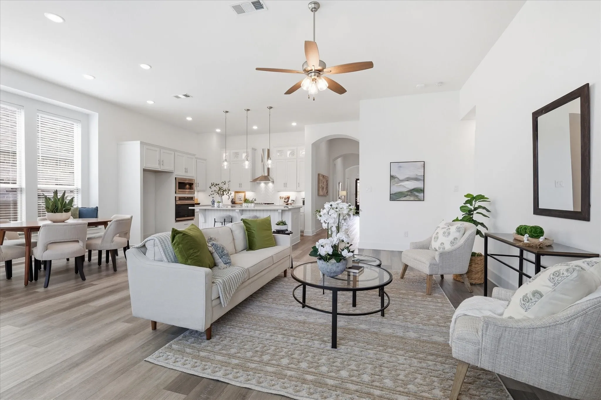 Living area with Luxury Vinyl flooring, natural light galore, gas fireplace and more!
