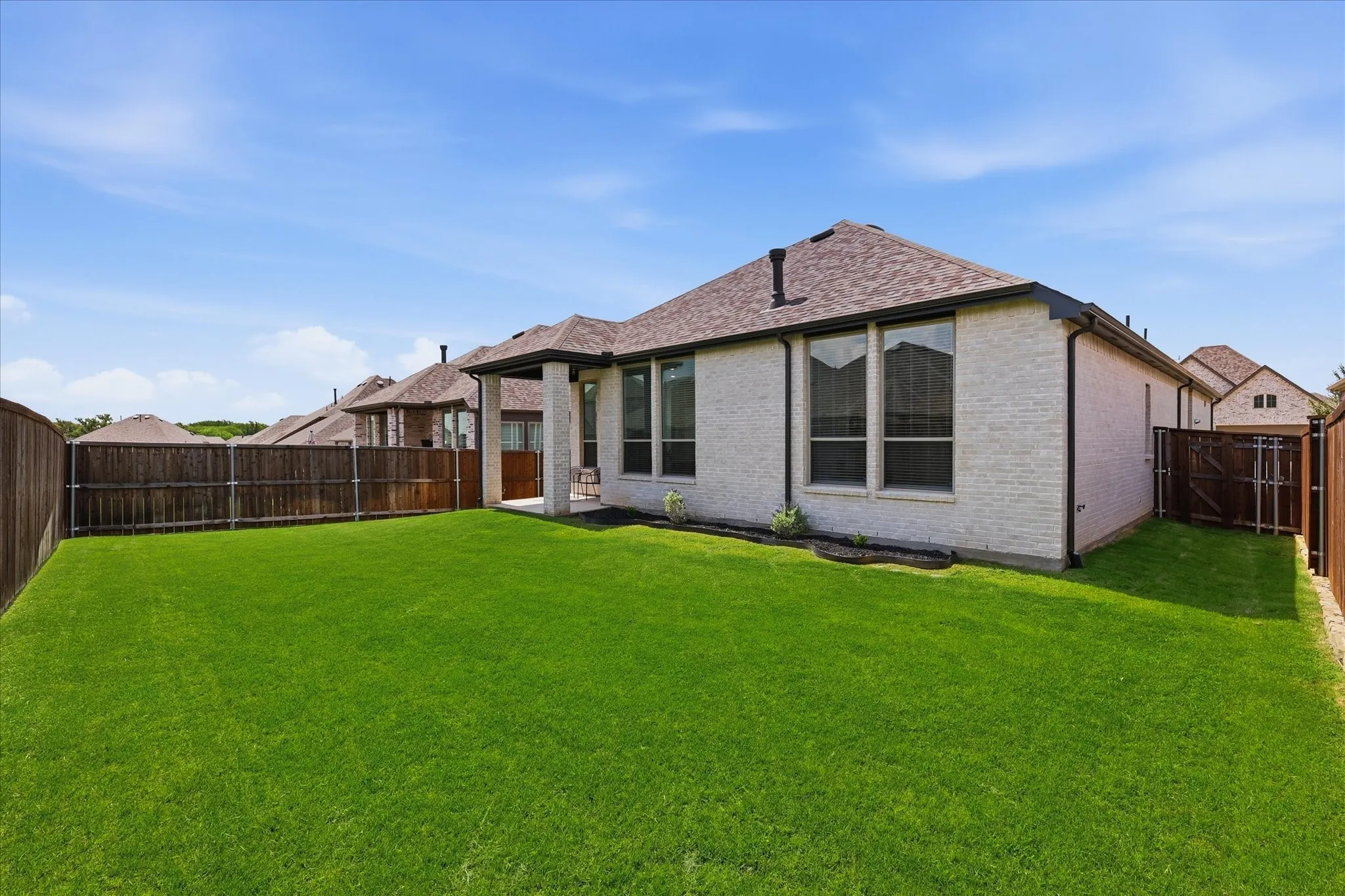 Large private backyard with new sod, flower beds for accents!