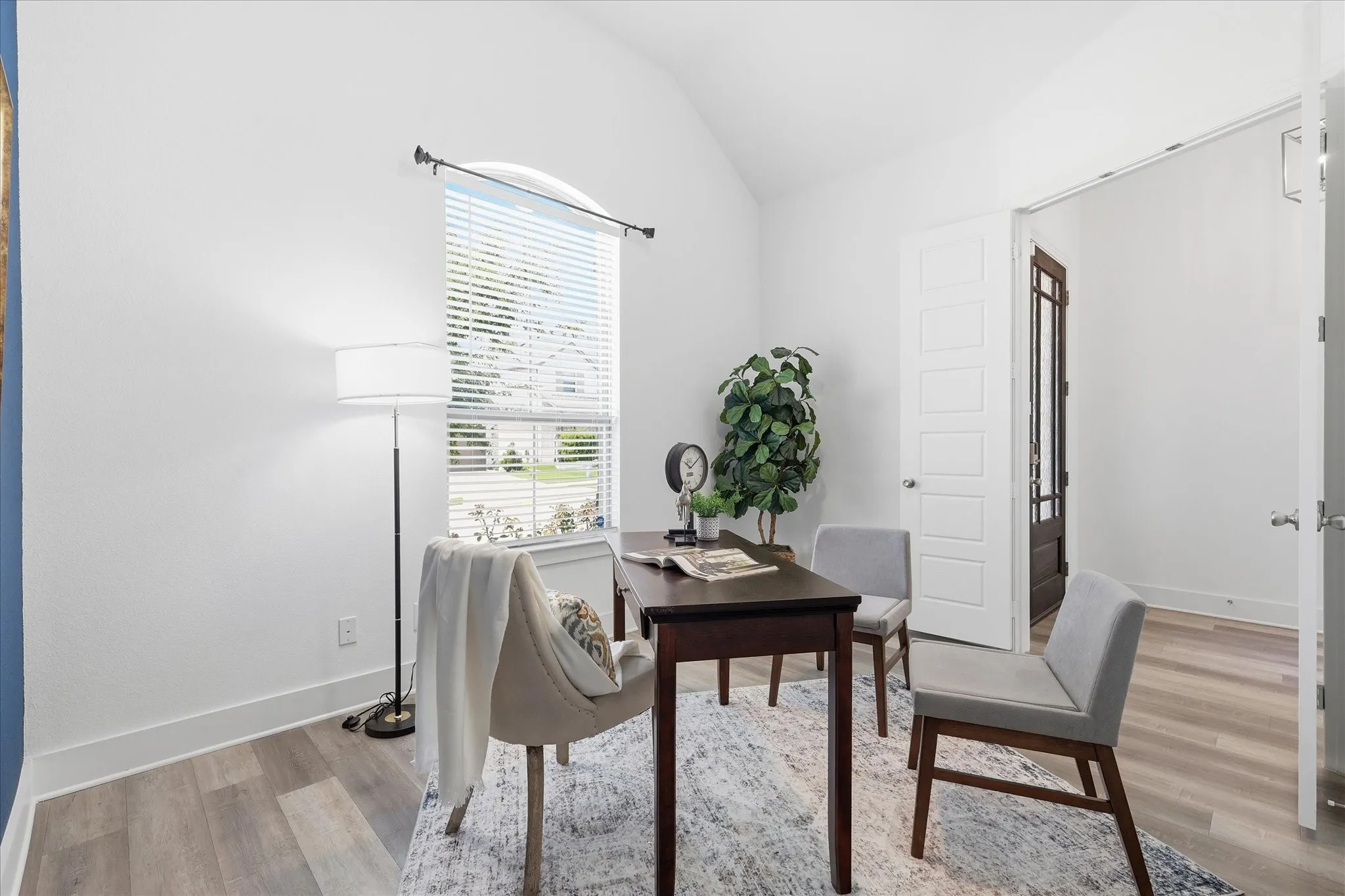 Vaulted ceiling office space with luxury vinyl flooring, custom paint, french doors and natural light
