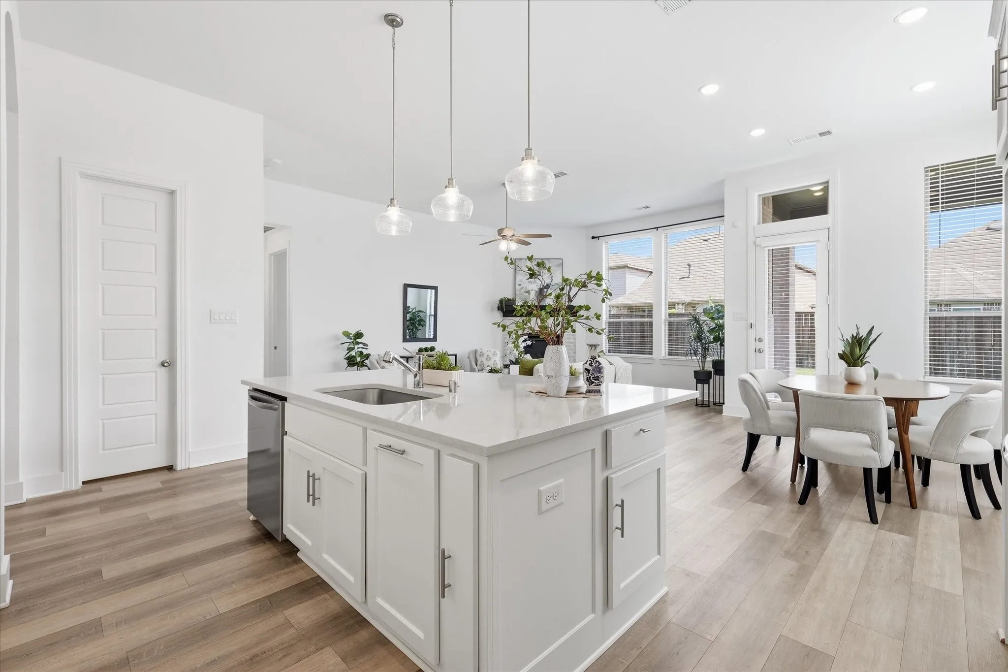 Open Concept kitchen with upgraded quartz countertops, SS gas appliances, natural lighting, and a large walk in pantry.