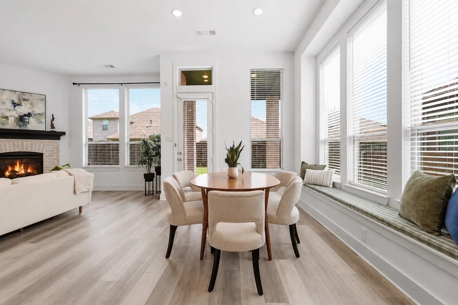 Open Concept dining area with custom bench seating, natural light and fresh paint!