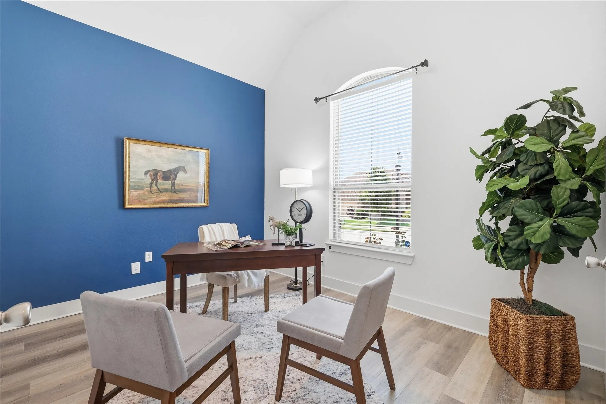 Vaulted ceiling office space with luxury vinyl flooring, custom paint, french doors and natural light