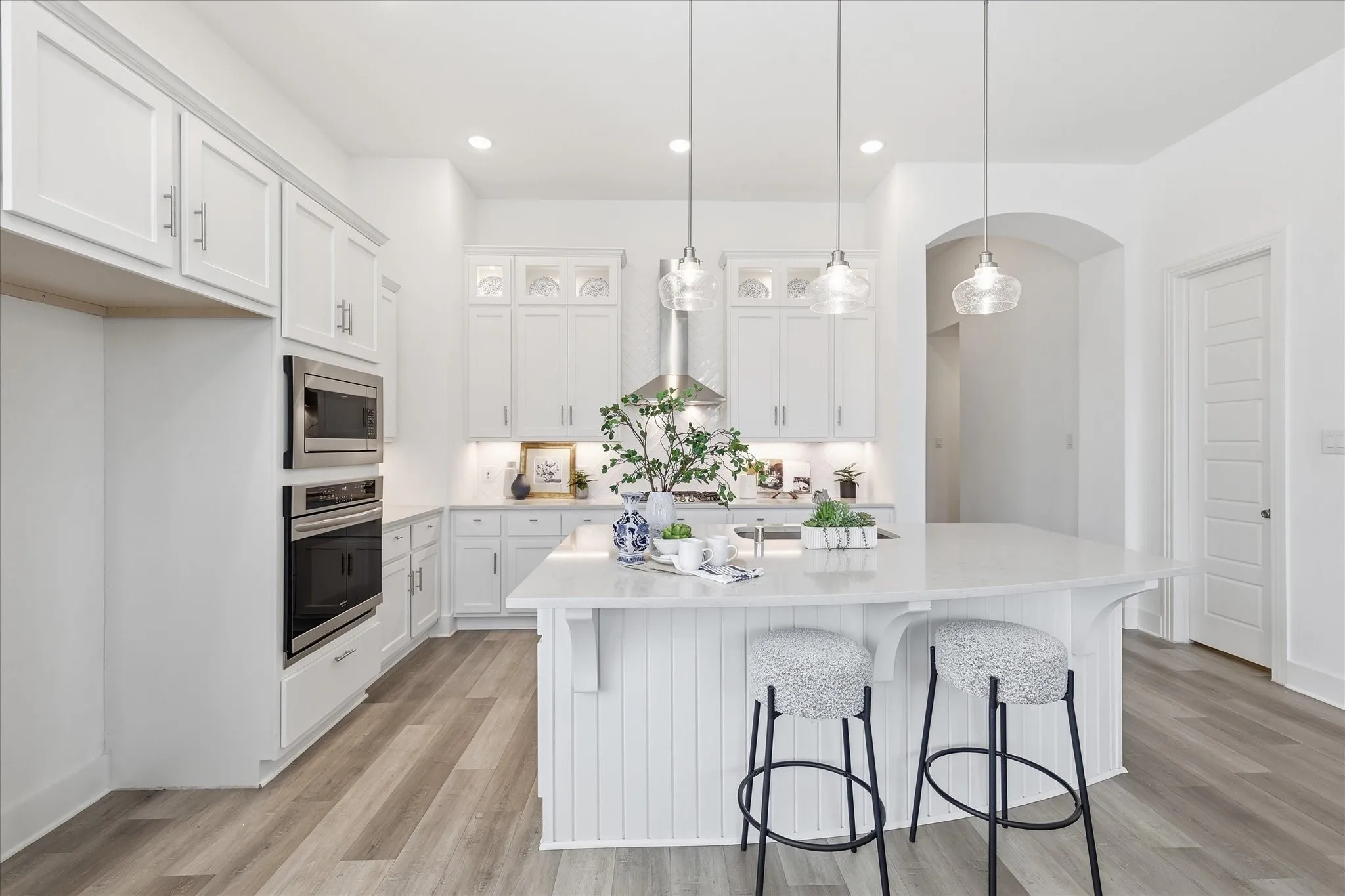 Open Concept kitchen with upgraded quartz countertops, SS gas appliances, natural lighting, and a large walk in pantry.