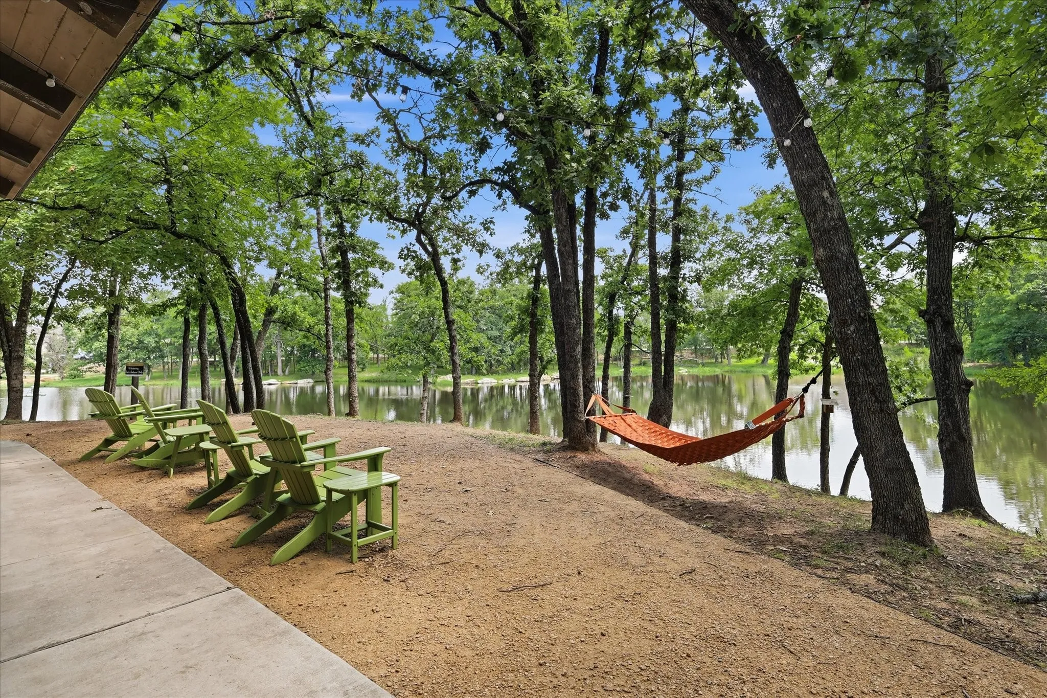 The Hideaway Pavilion where residents are able to view the 3-acre fishing pond from the comforts of hammocks in the trees or Adirondack chairs.
