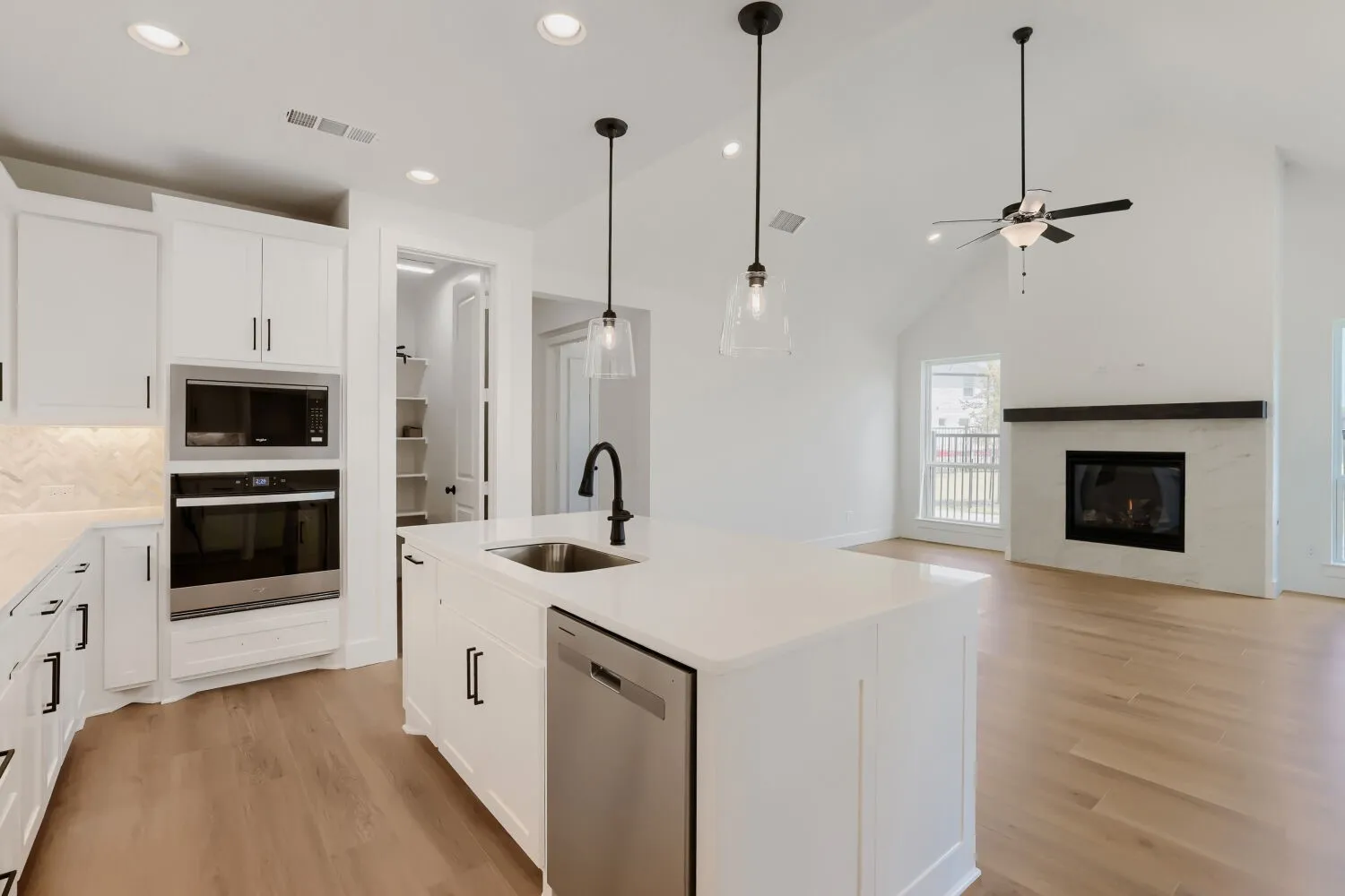 Open-concept kitchen and living area featuring a vaulted ceiling
