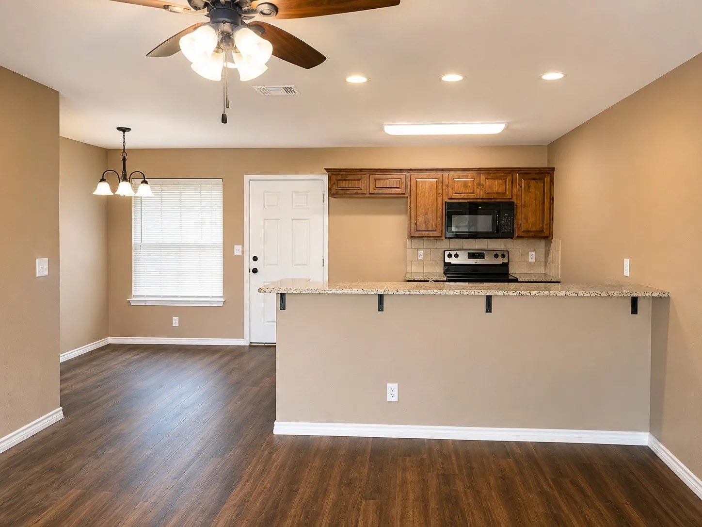 Open-concept living space with wood-finish flooring