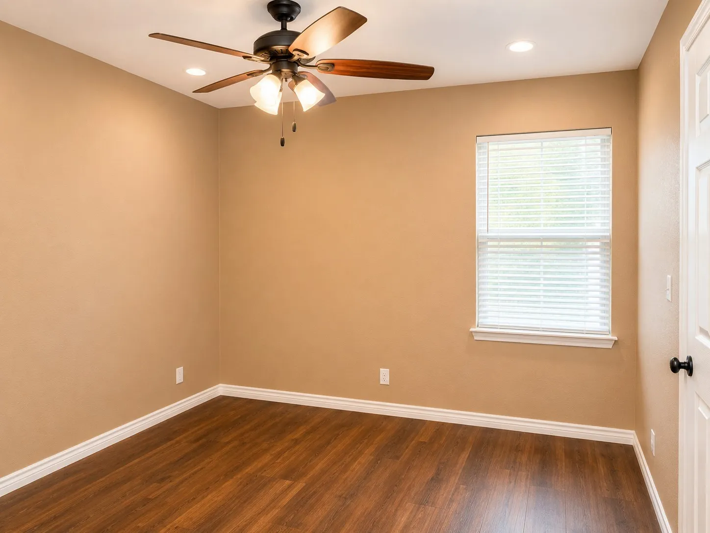 Room featuring wood-finish flooring, recessed lighting, and a ceiling fan with light kit