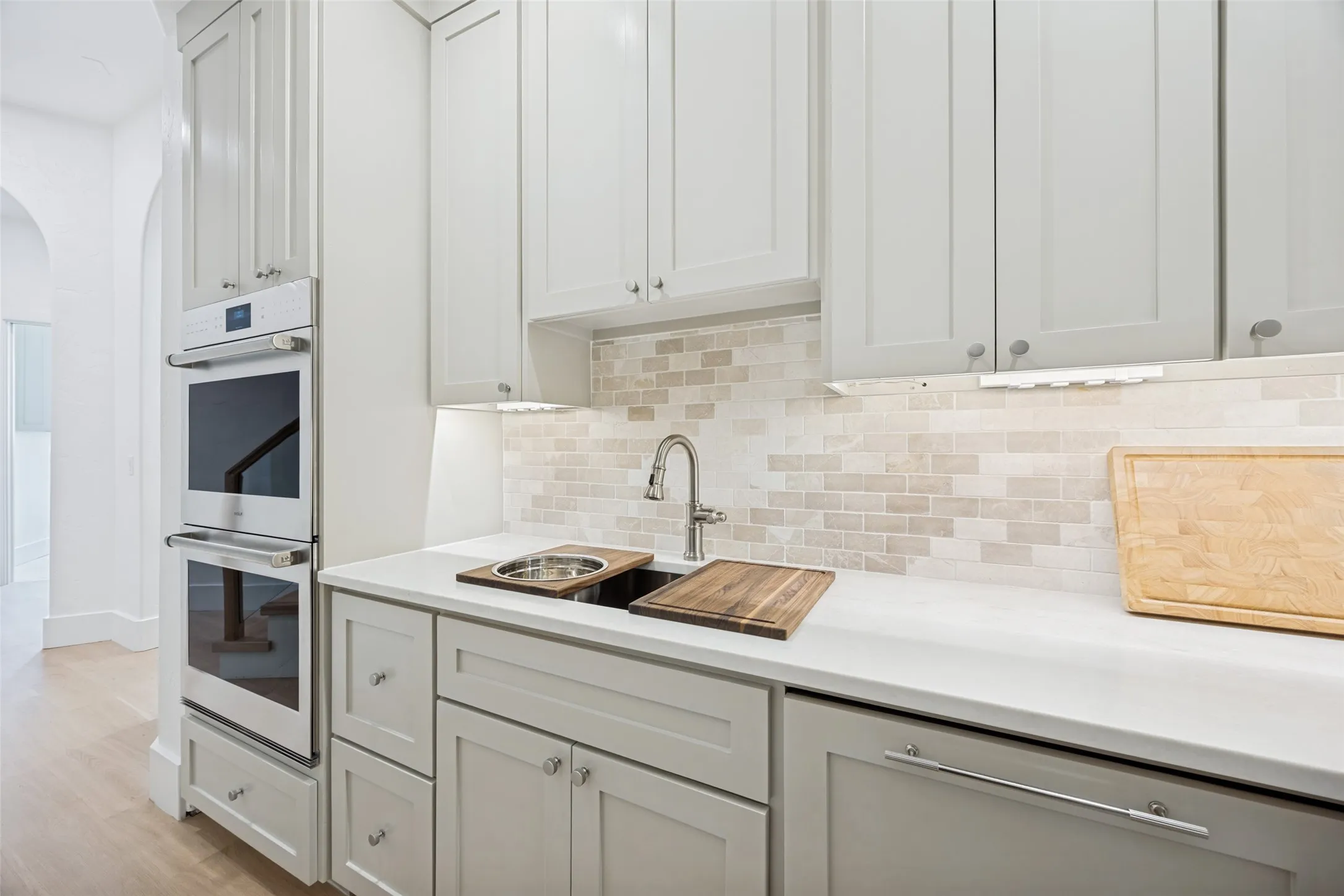 Catering kitchen with Wolf double ovens and a third Cove dishwasher.