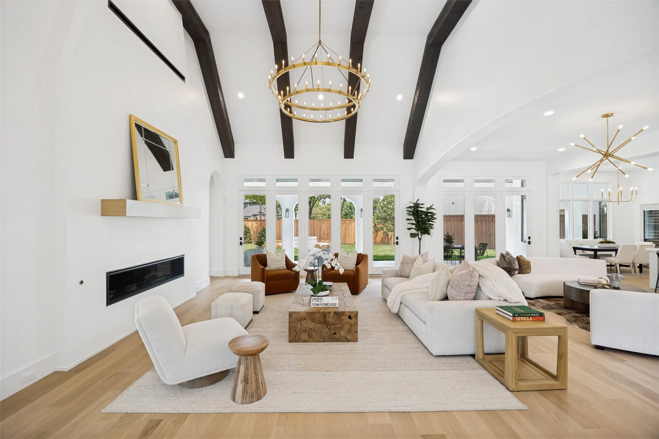 An entire wall of windows and doors open to the patio bathe the room in natural light.