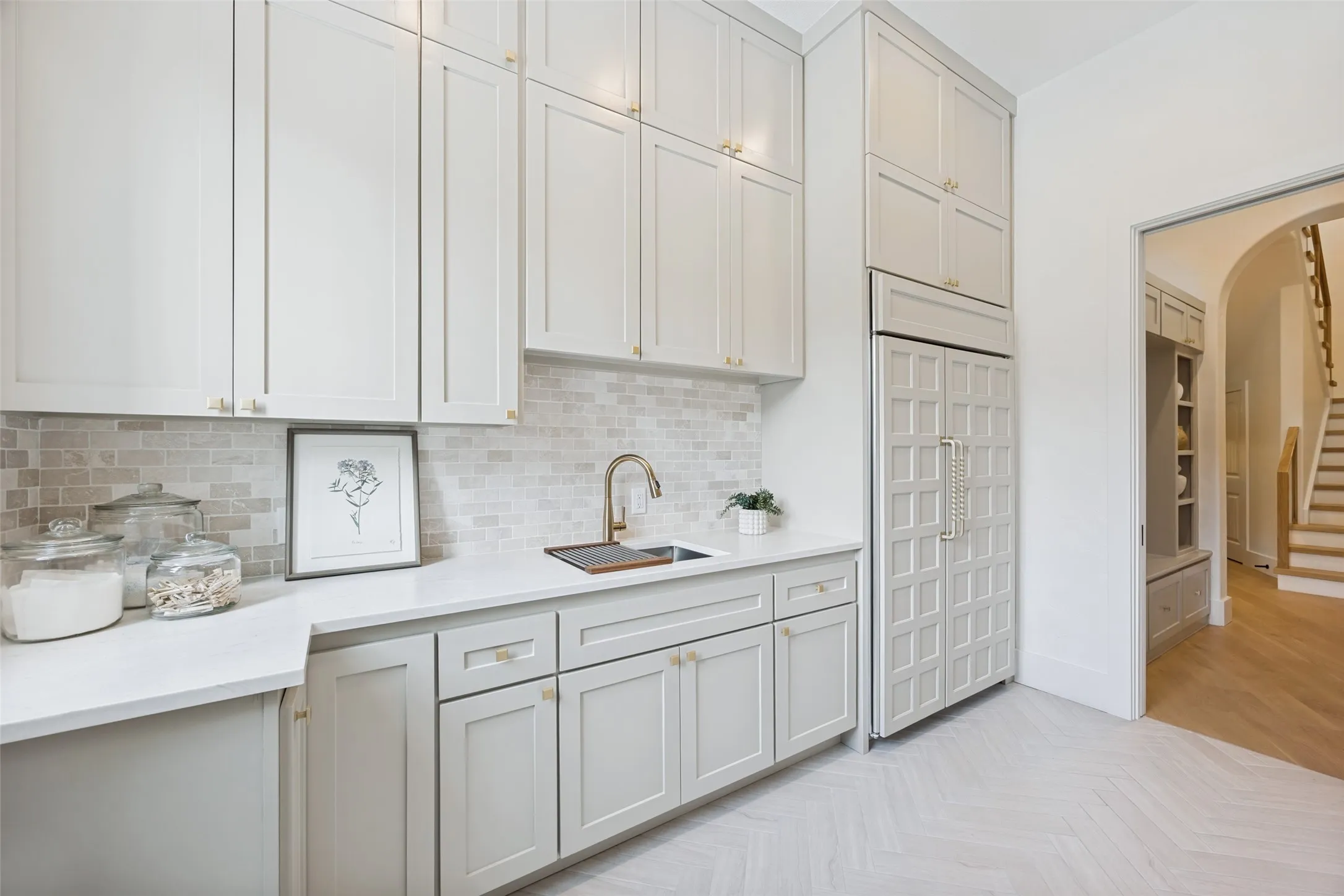Downstairs laundry room with GE Monogram fridge/freezer.