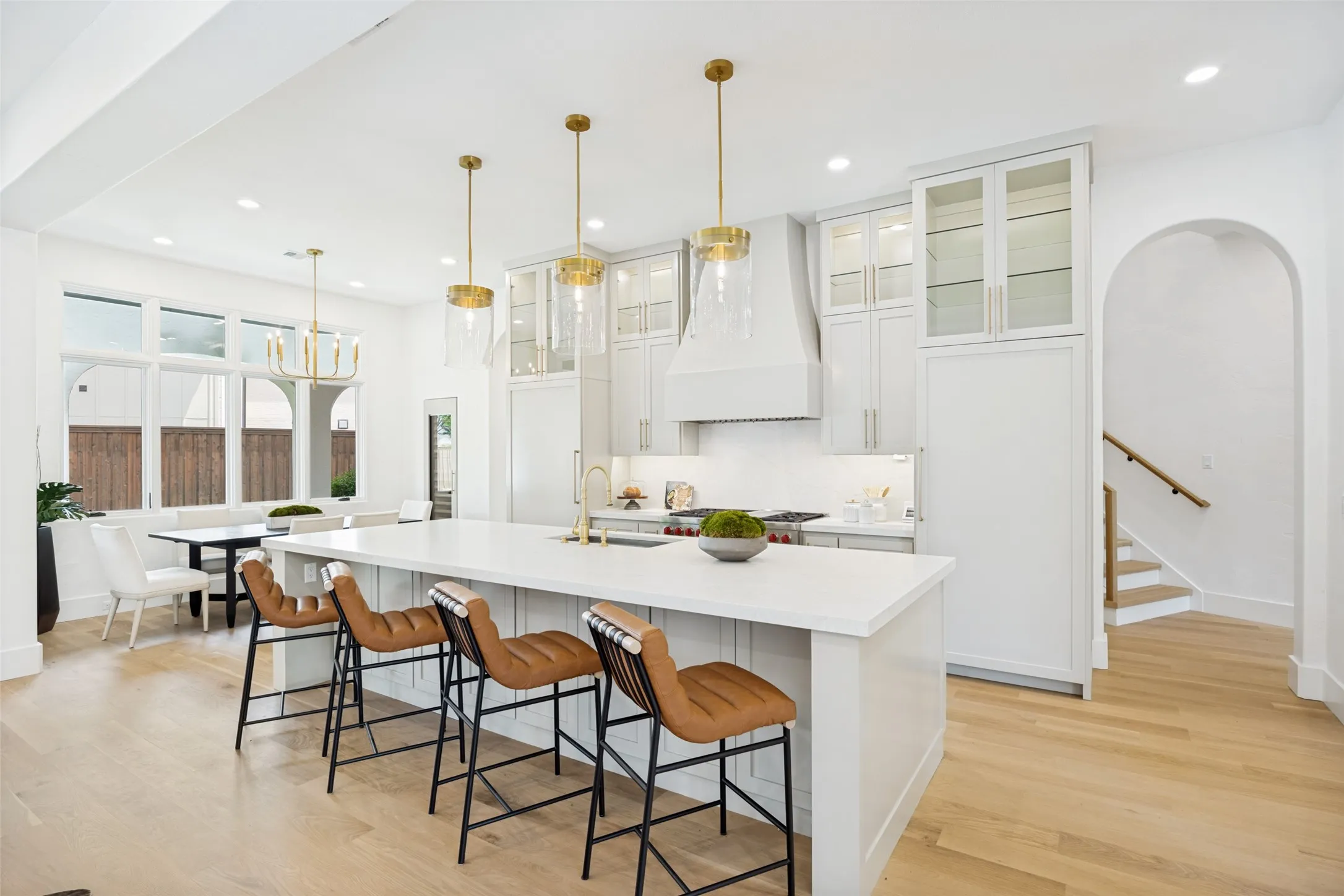 Seating at the island. Sub-Zero fridge on the right, freezer on the left of the range