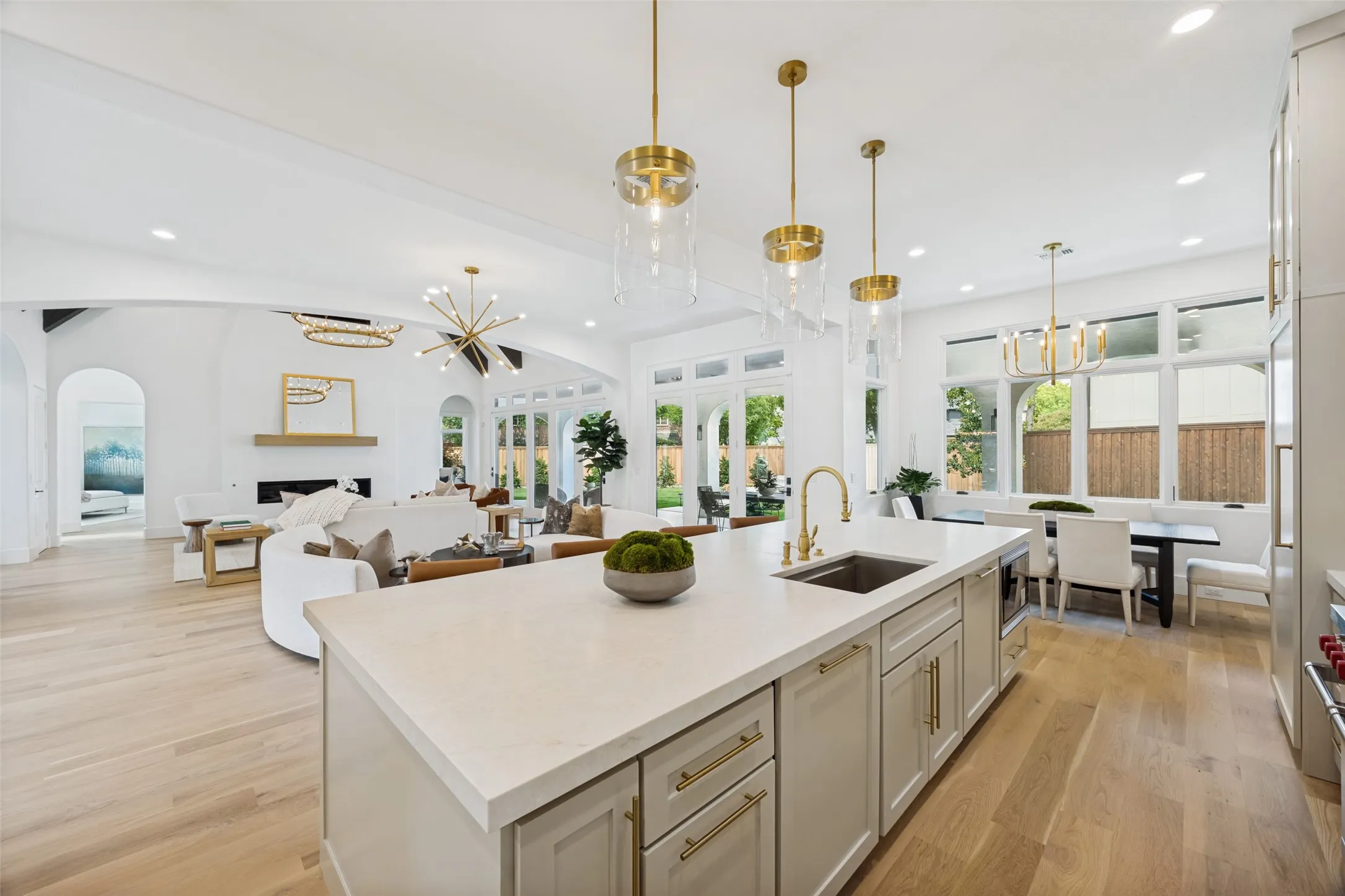Huge island clad in quartzite. Two cove dishwashers, built in Wolf microwave.