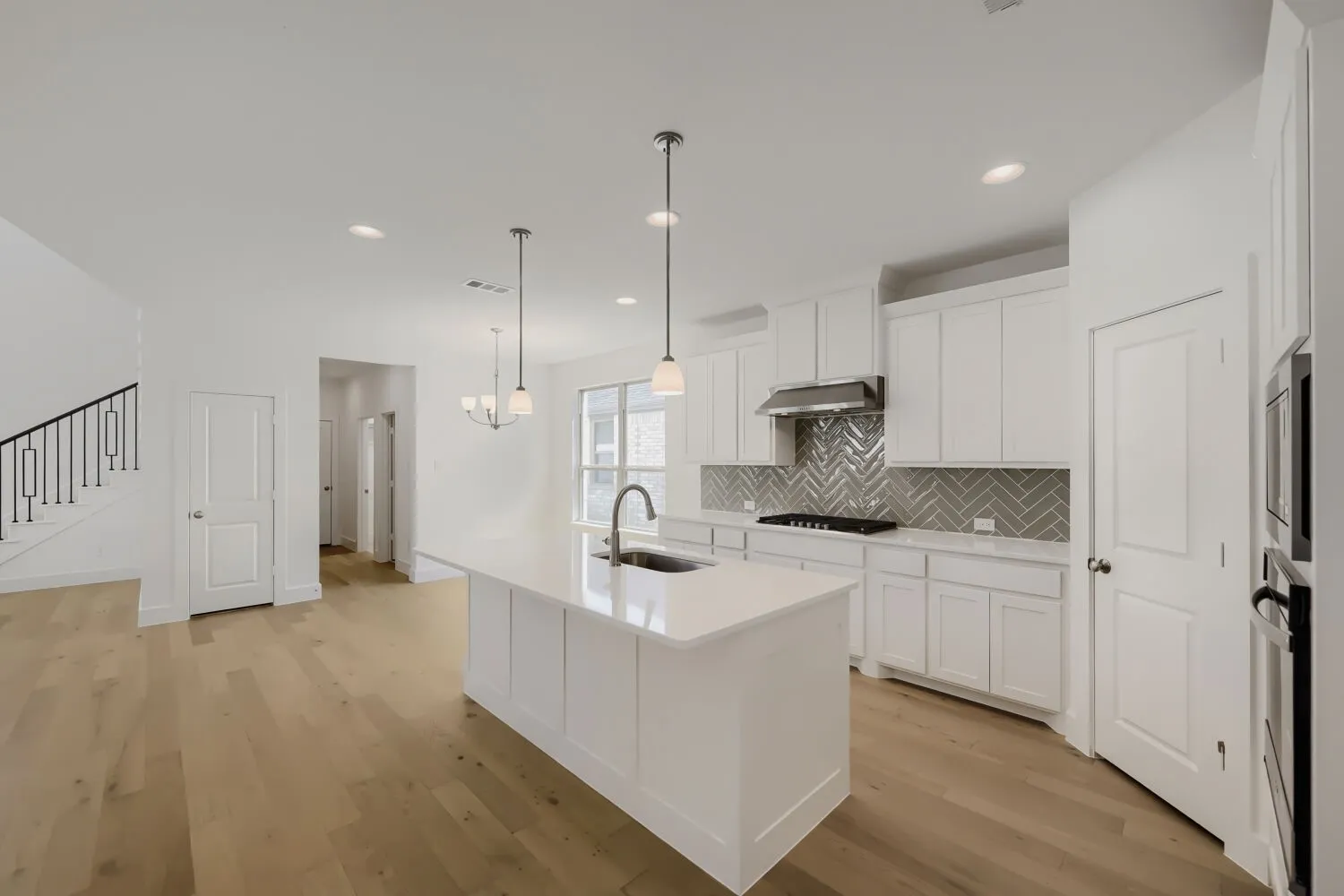 Virtually Staged Photo - Vaulted ceiling with a flush-mount light fixture, paneled interior doors, and a window with curtain rod and drapes