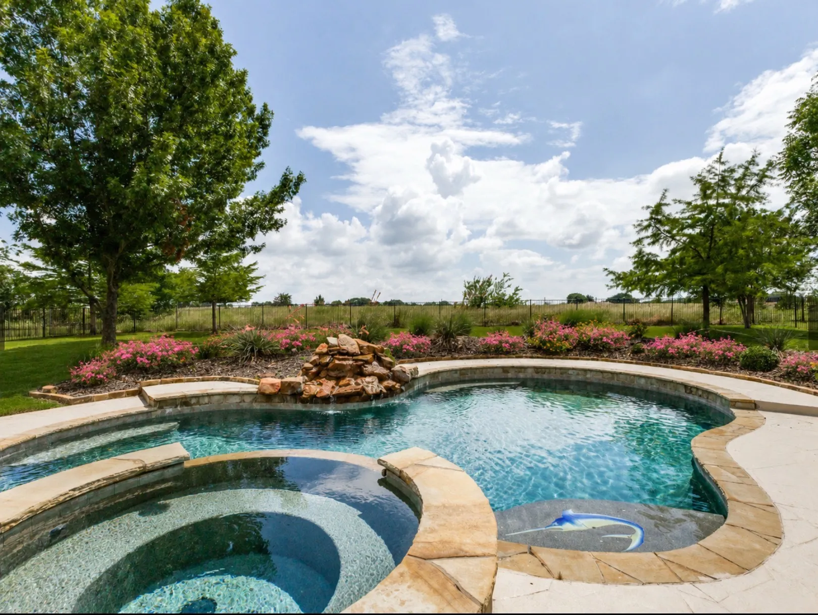 Pool has a tiered spa perfect for small children to plat. Stone edging