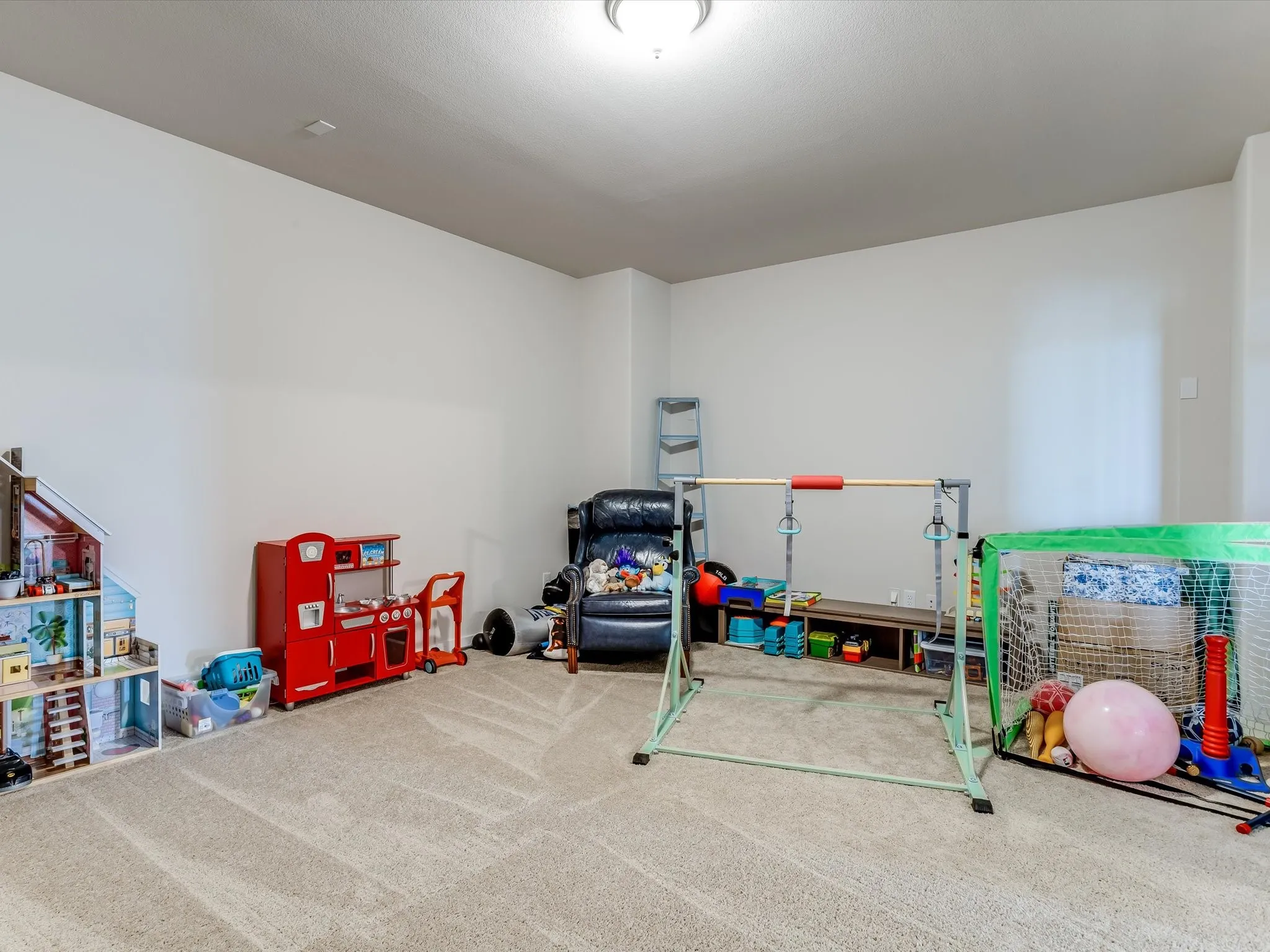 Carpeted room with neutral wall tones and a ceiling-mounted light fixture