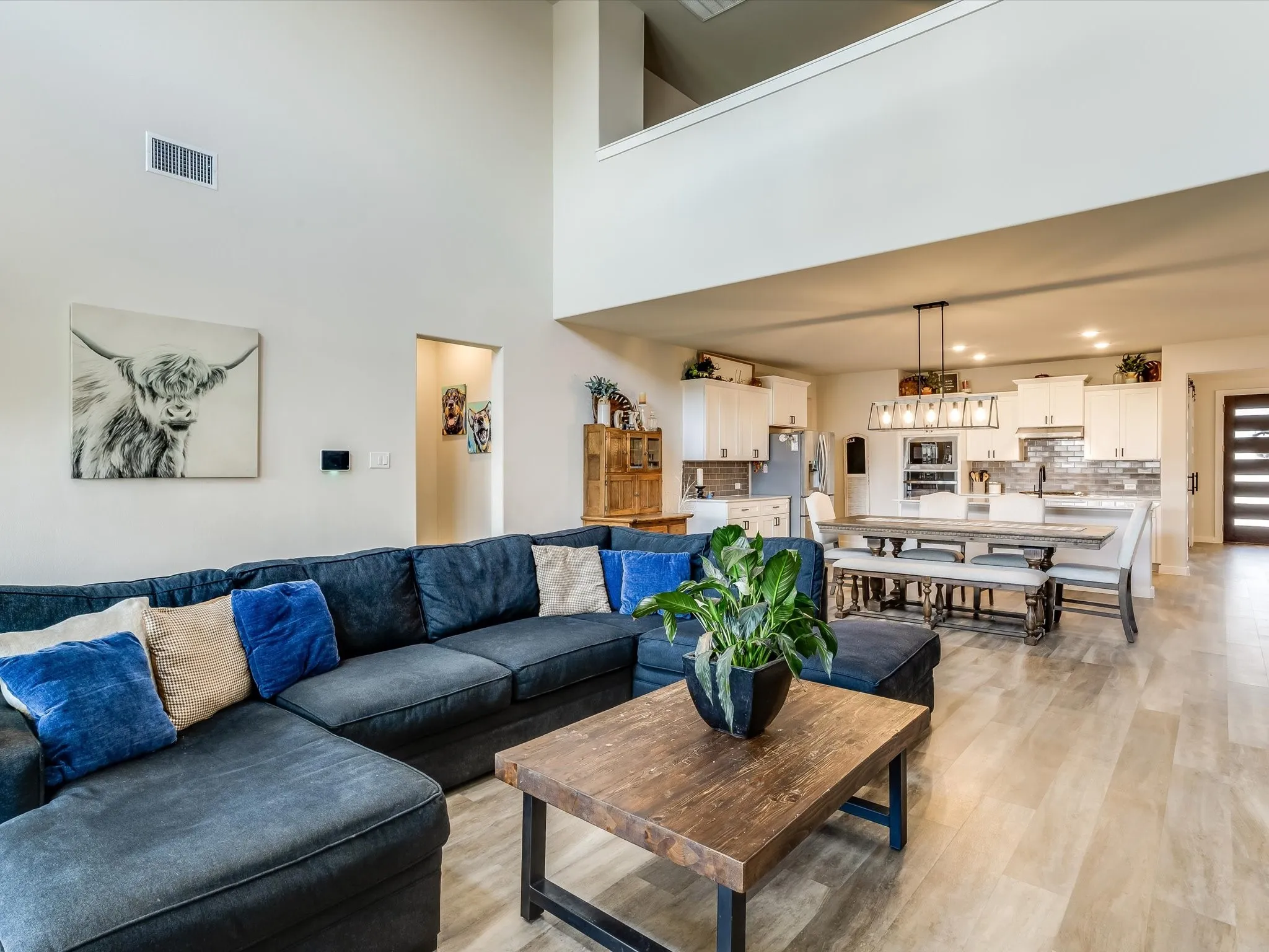 Expansive living area featuring soaring ceilings and wood-finish flooring