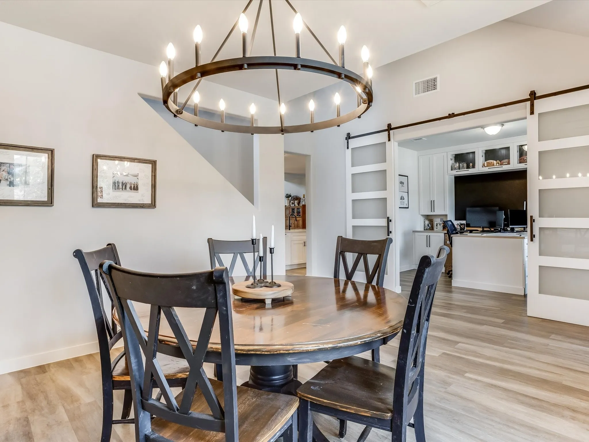 Dining area featuring a contemporary circular chandelier and wood-finish flooring