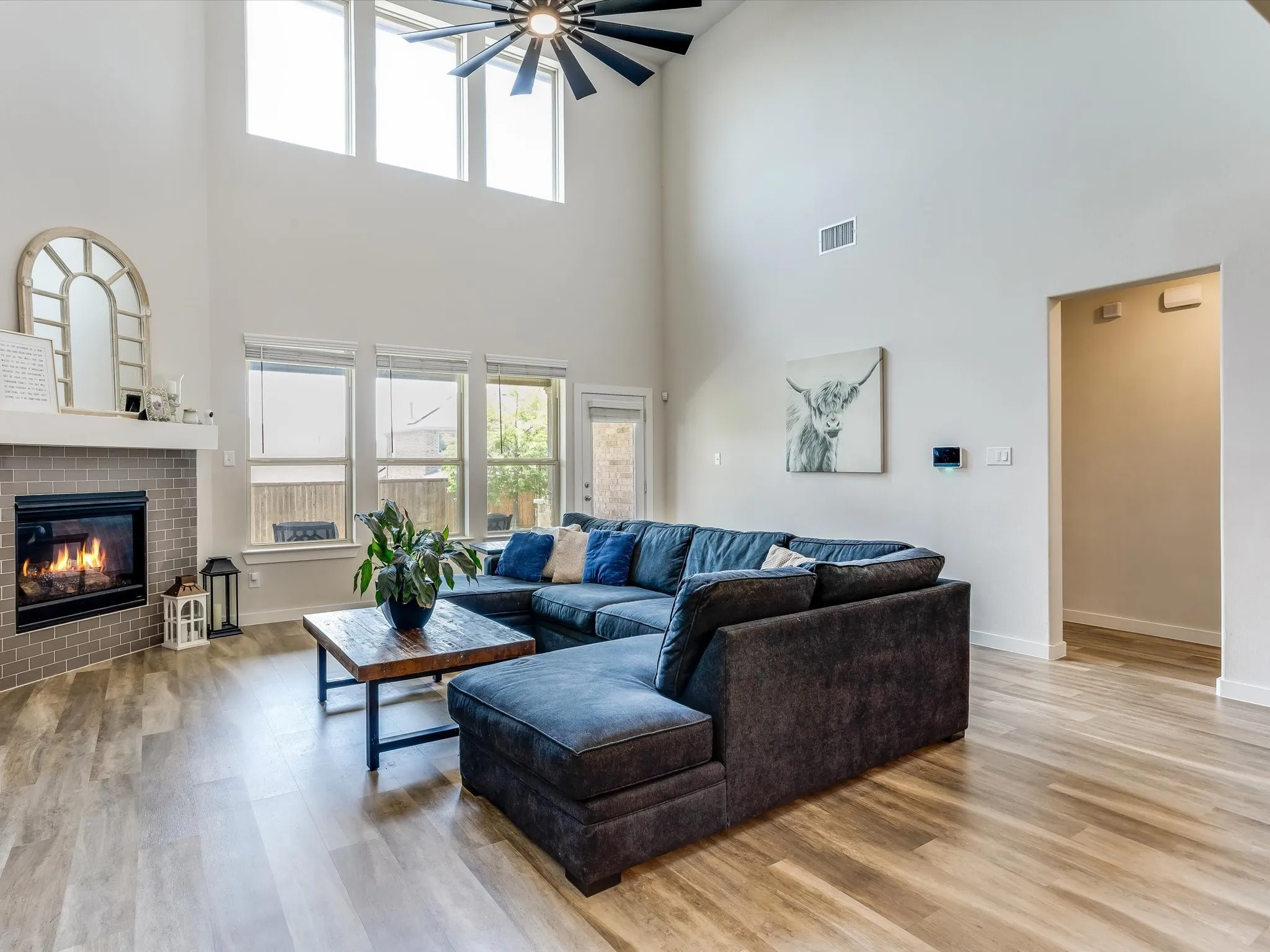 Vaulted ceilings with an exposed beam fan define this living space