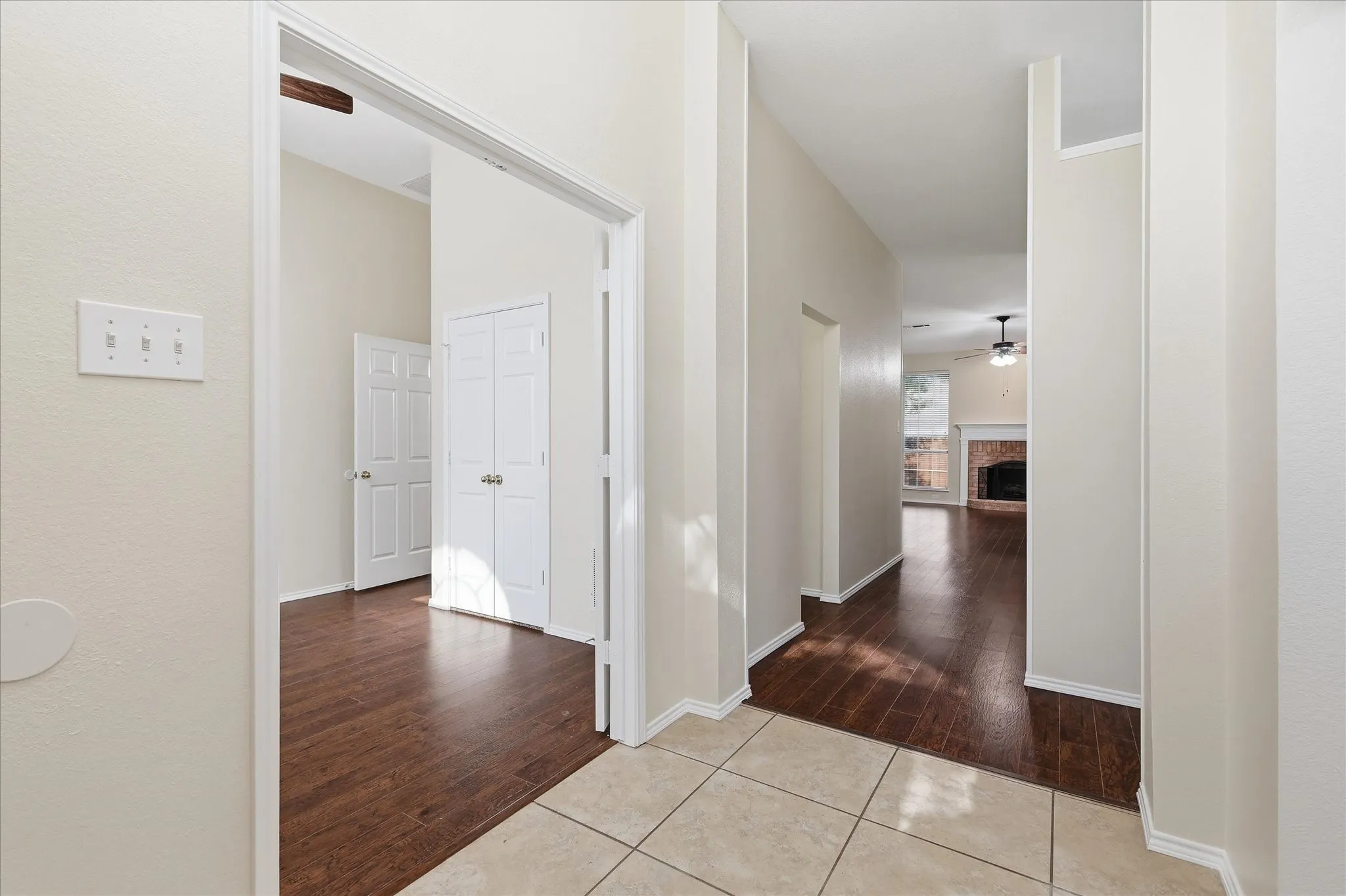 Tiled entryway transitioning to wood-finish flooring