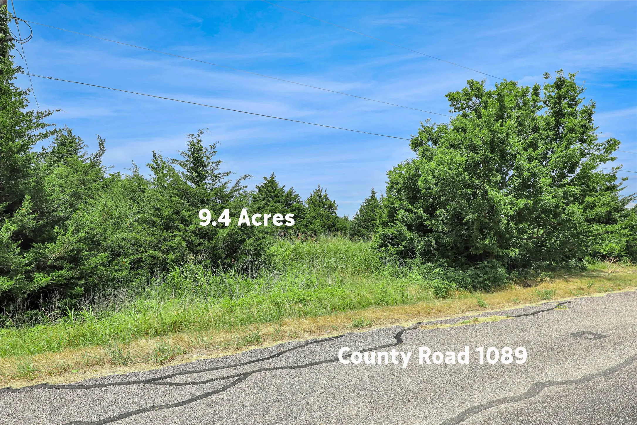 9.4 acres of undeveloped land featuring varied terrain and mature trees
