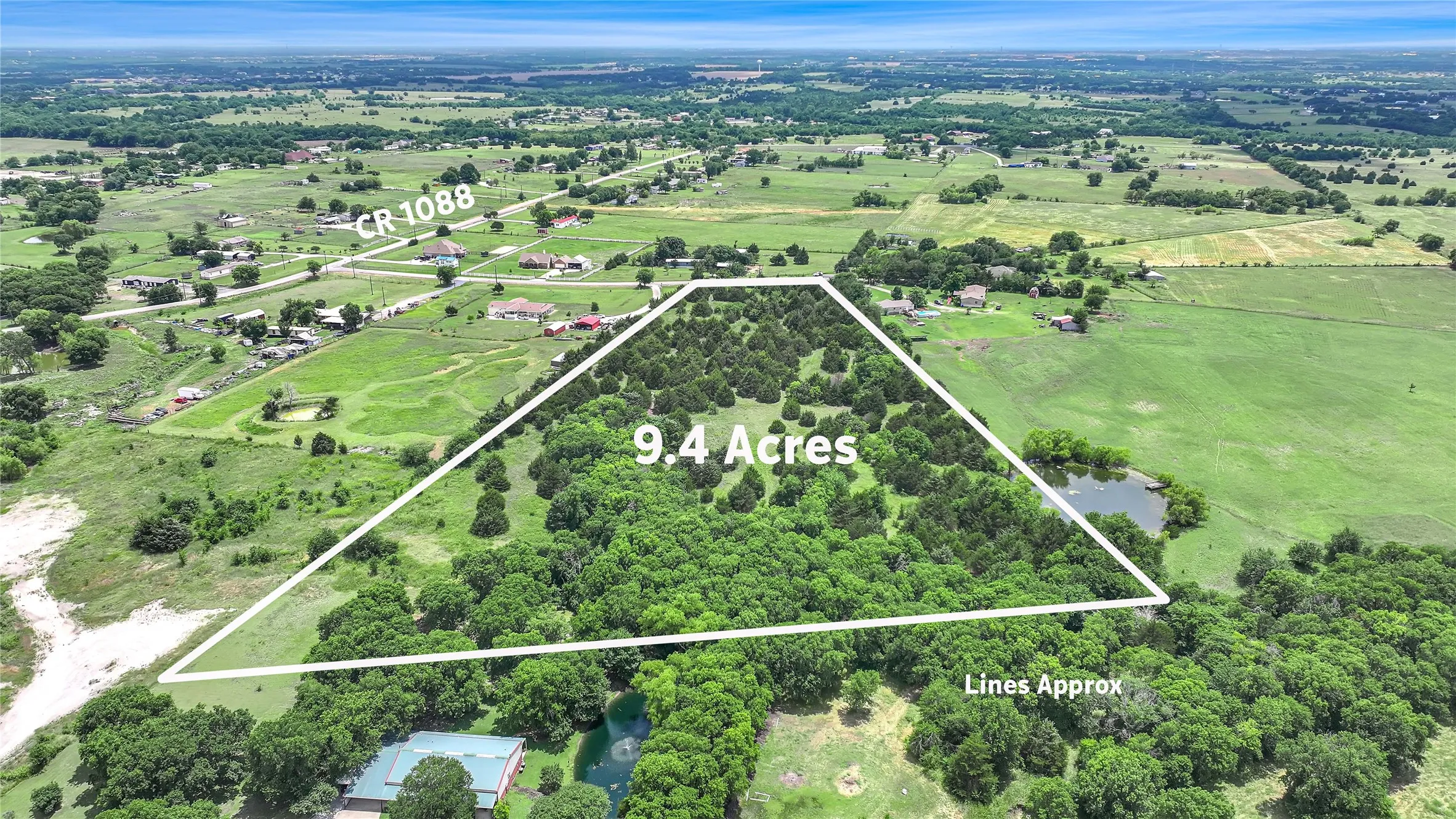 Aerial perspective showcasing 9.4 acres of land with extensive tree coverage