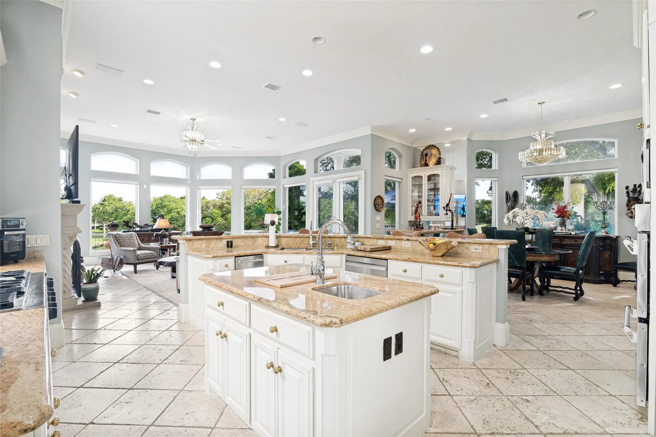 Kitchen with view to breakfast area and family room. Island with second sink