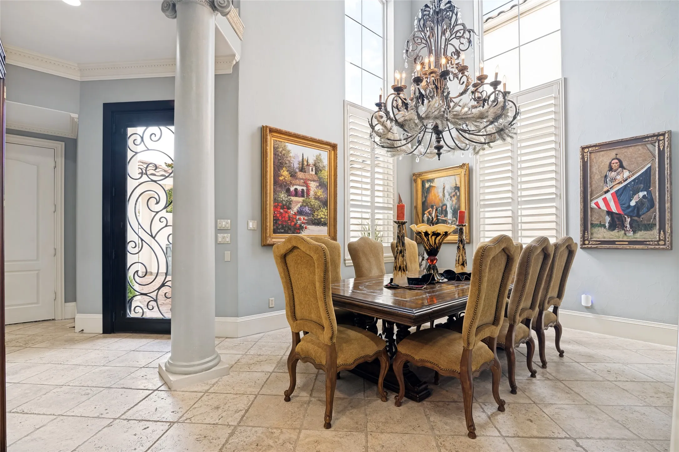 Elegant chandelier and plantation shutters finish this room nicely