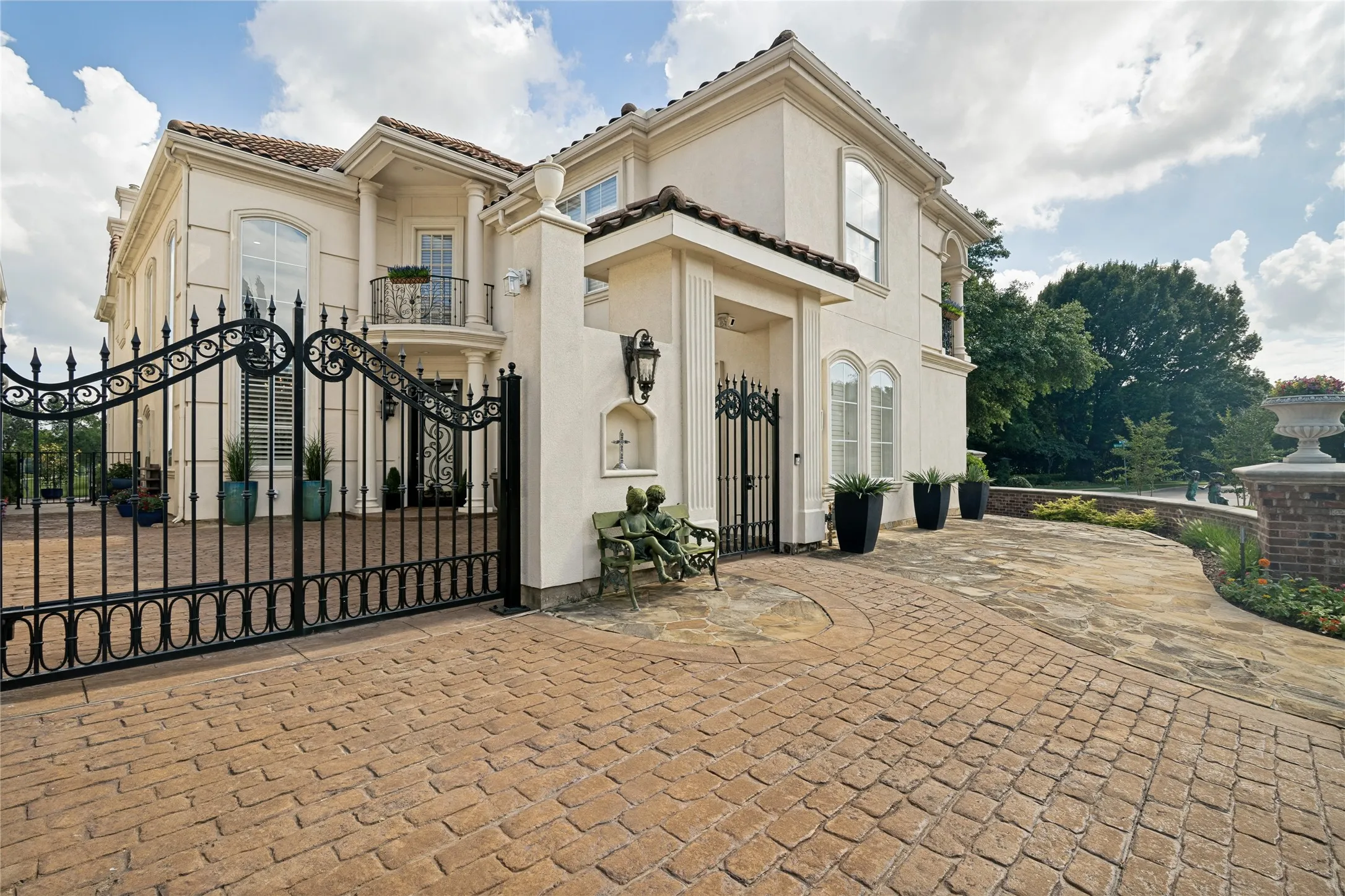 Stately iron gate secures the courtyard and entry to the home.