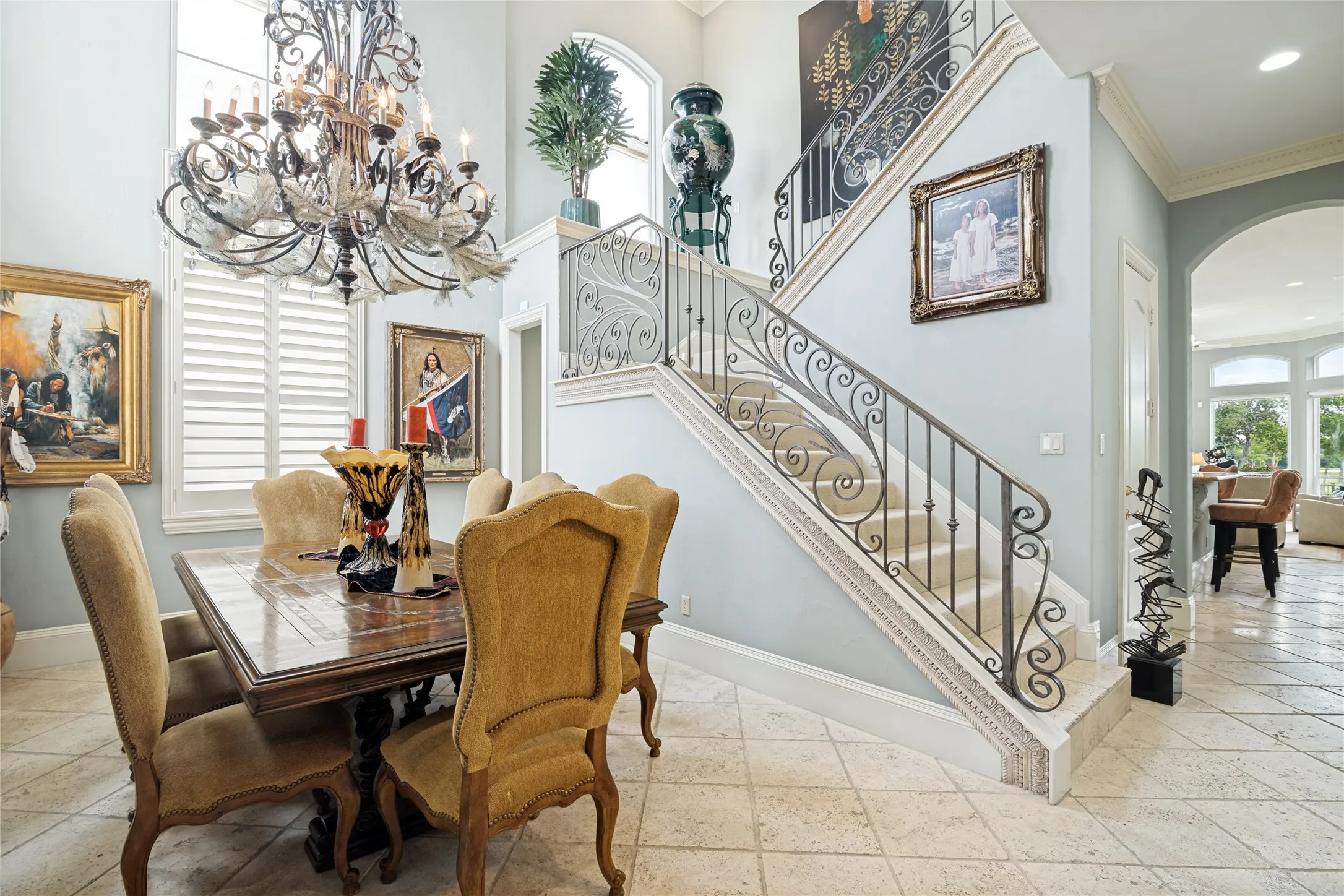 Two story entry with graceful staircase and views through the kitchen and family room to the golf views