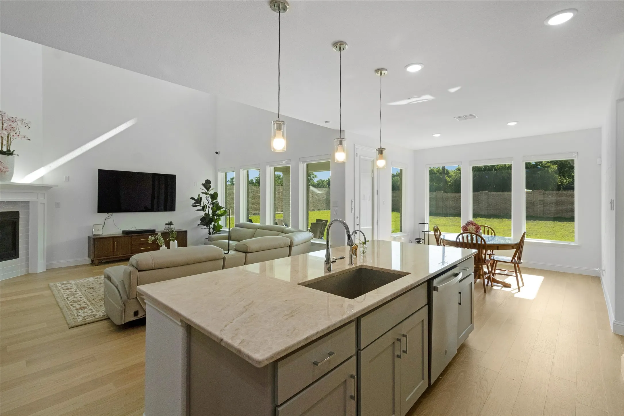 Open concept living area with vaulted ceilings and light wood-finish flooring