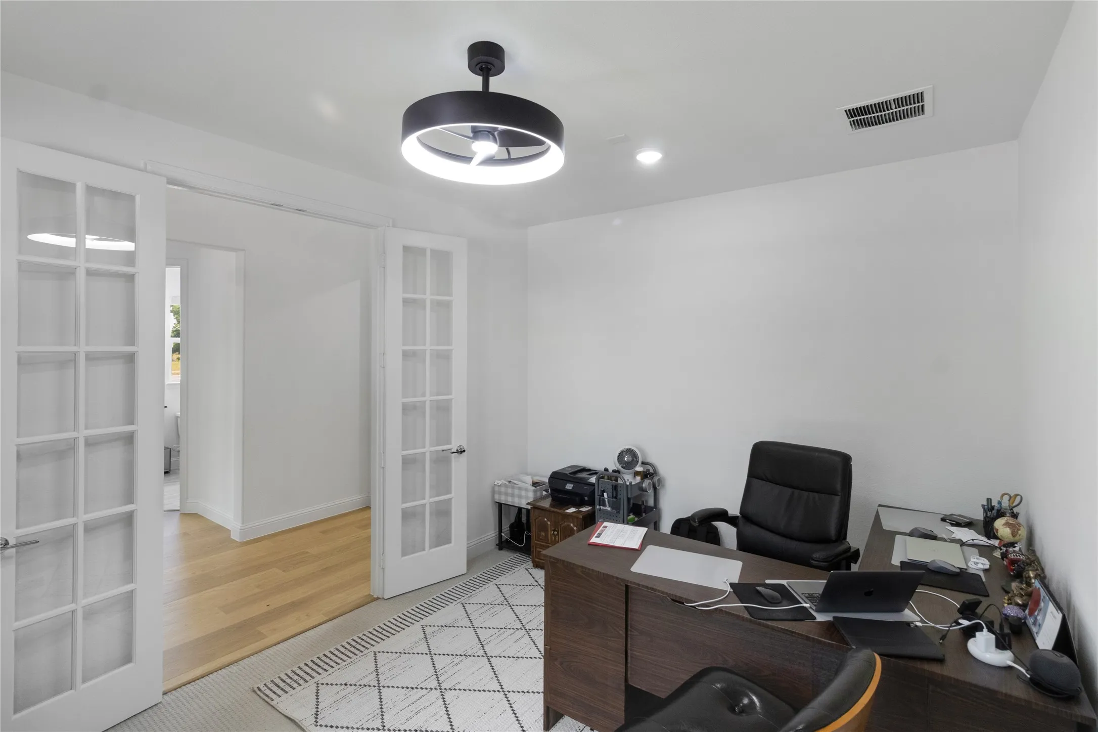 Room featuring double French doors, recessed lighting, and a modern ceiling light fixture. Office or bonus room