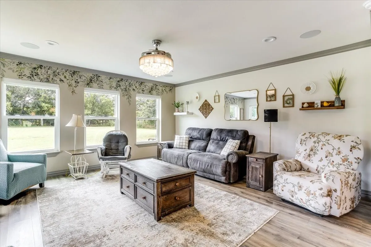 Spacious living area featuring wood-finish flooring, recessed lighting, and a decorative ceiling fan