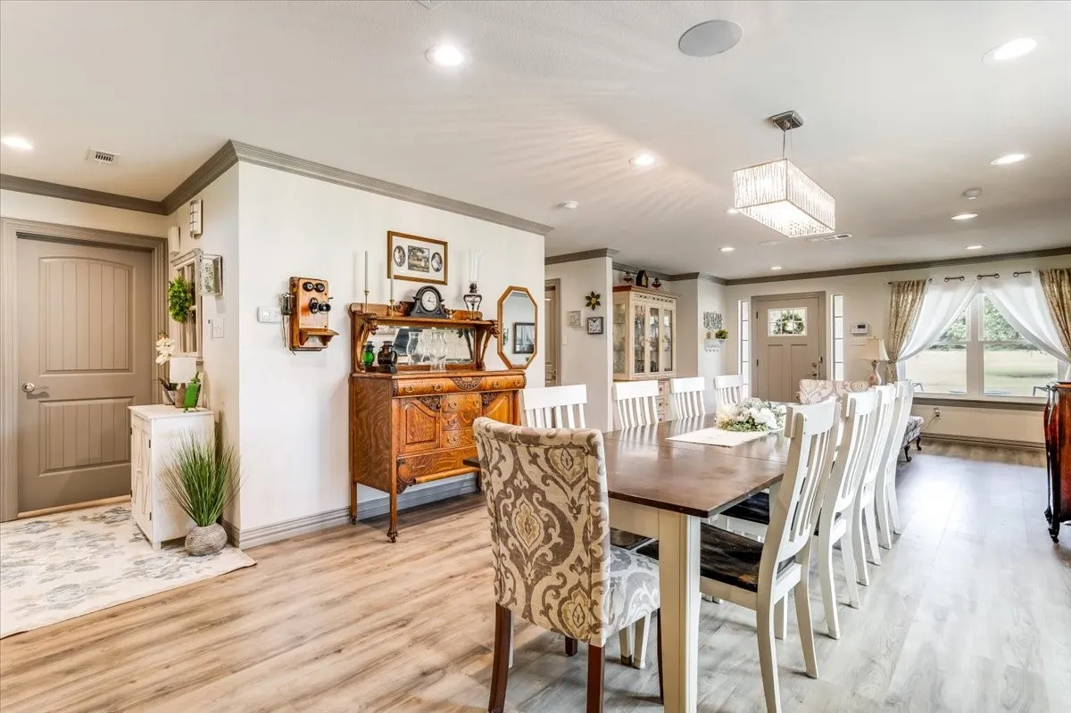 Open concept dining area featuring wood-finish flooring and recessed lighting