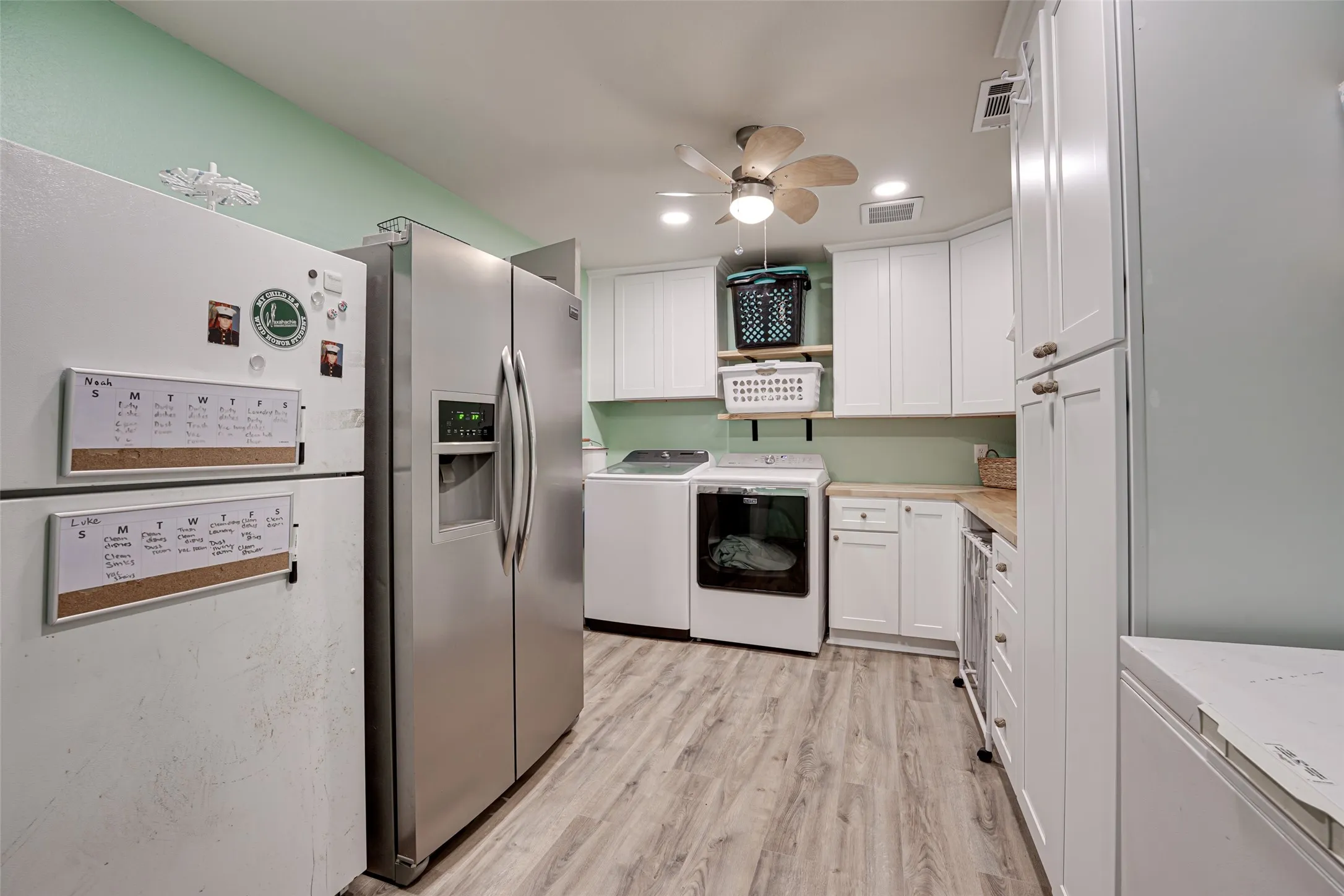 Utility space featuring light wood-finish flooring and a ceiling fan
