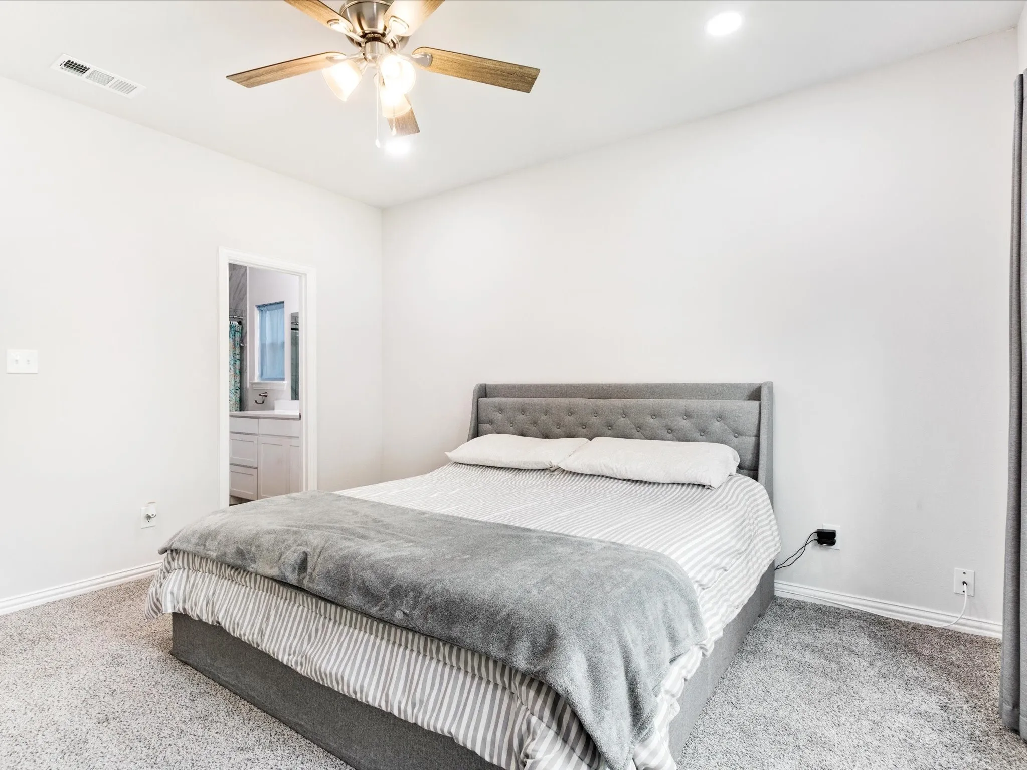 Bedroom featuring light gray carpet flooring and white walls