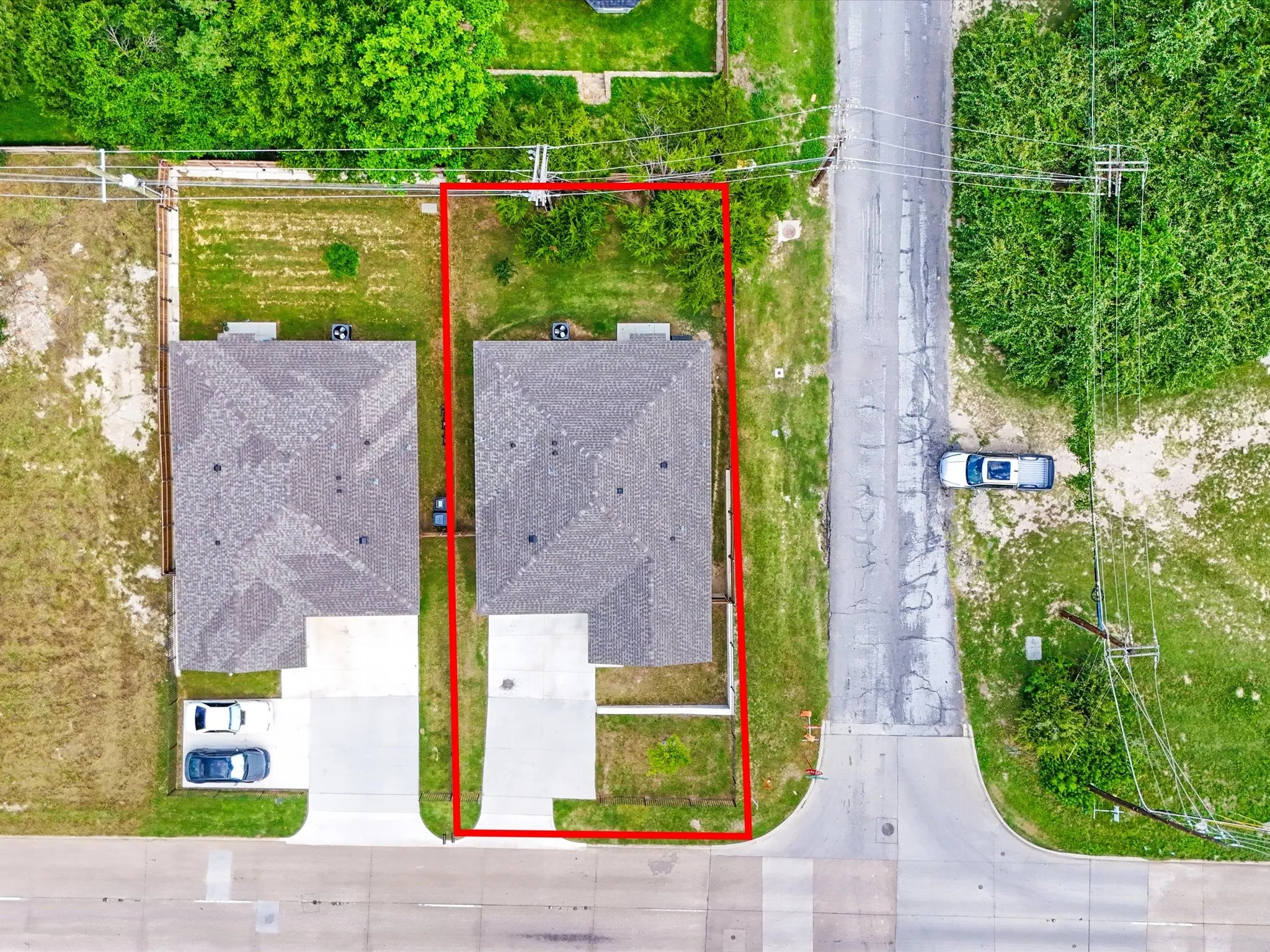 Aerial view showcasing a residential property with a clearly defined boundary