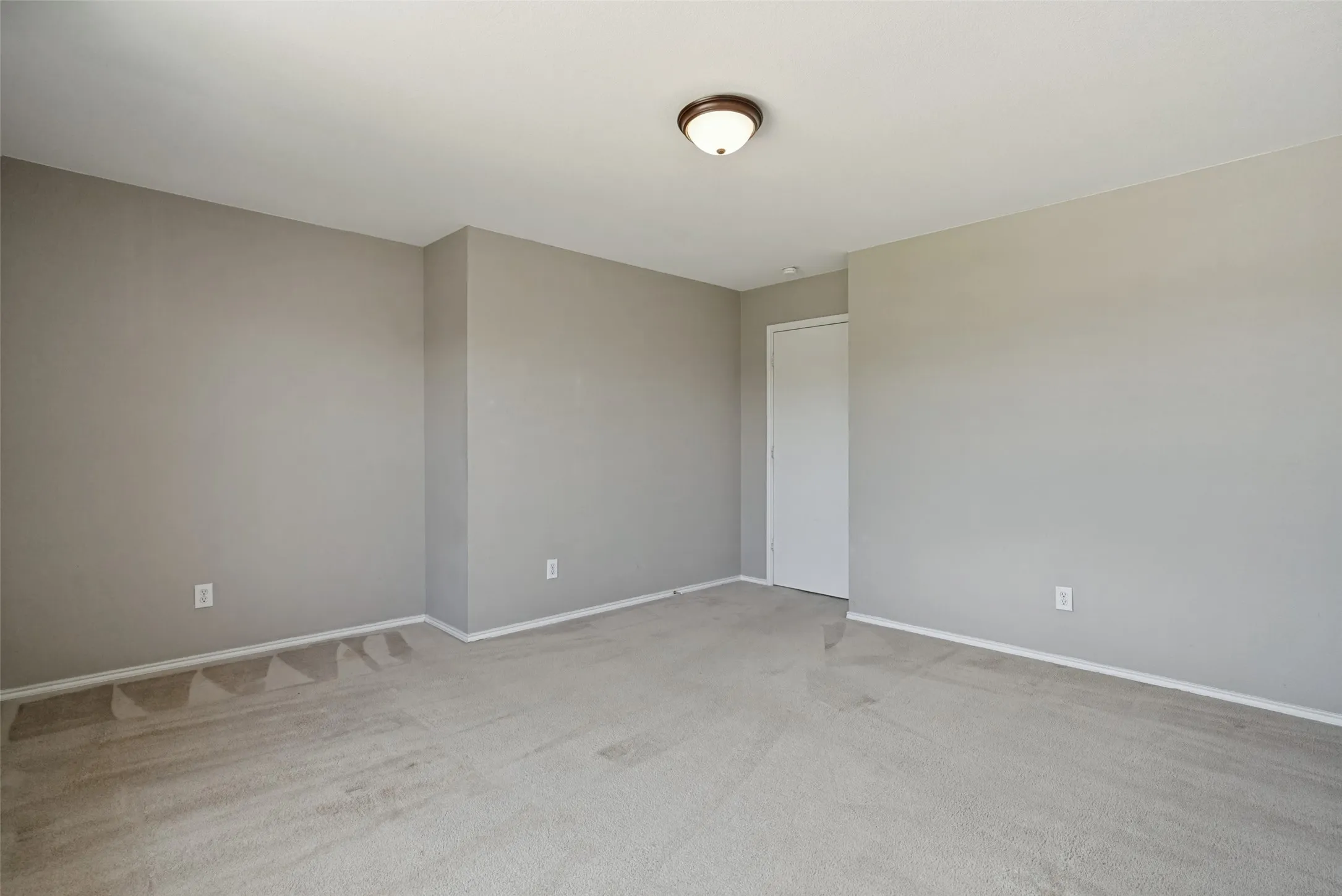 Neutral tone walls complemented by light-colored carpeting