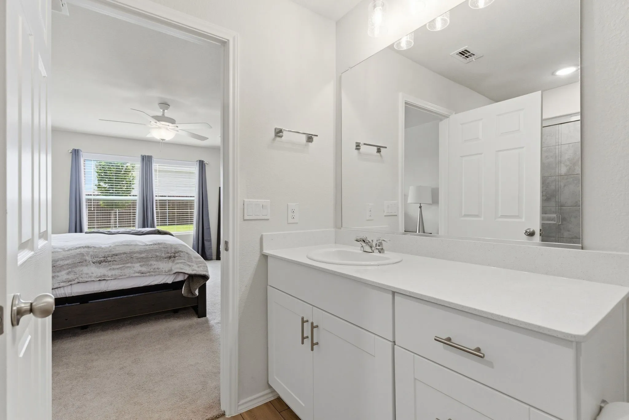 Bathroom vanity featuring a silestone quartz countertop with an undermount sink and chrome faucet