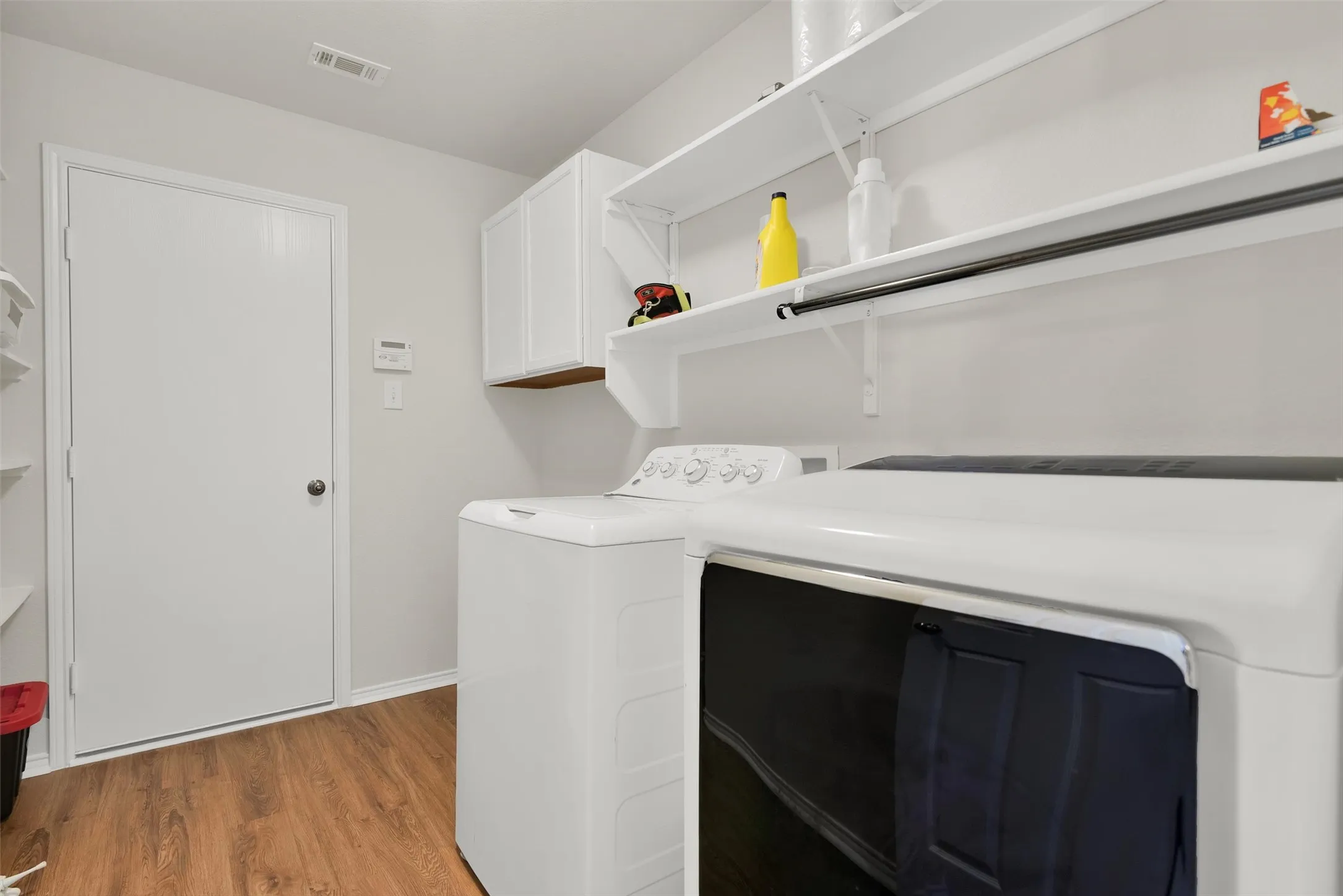 Large laundry room with storage shelving