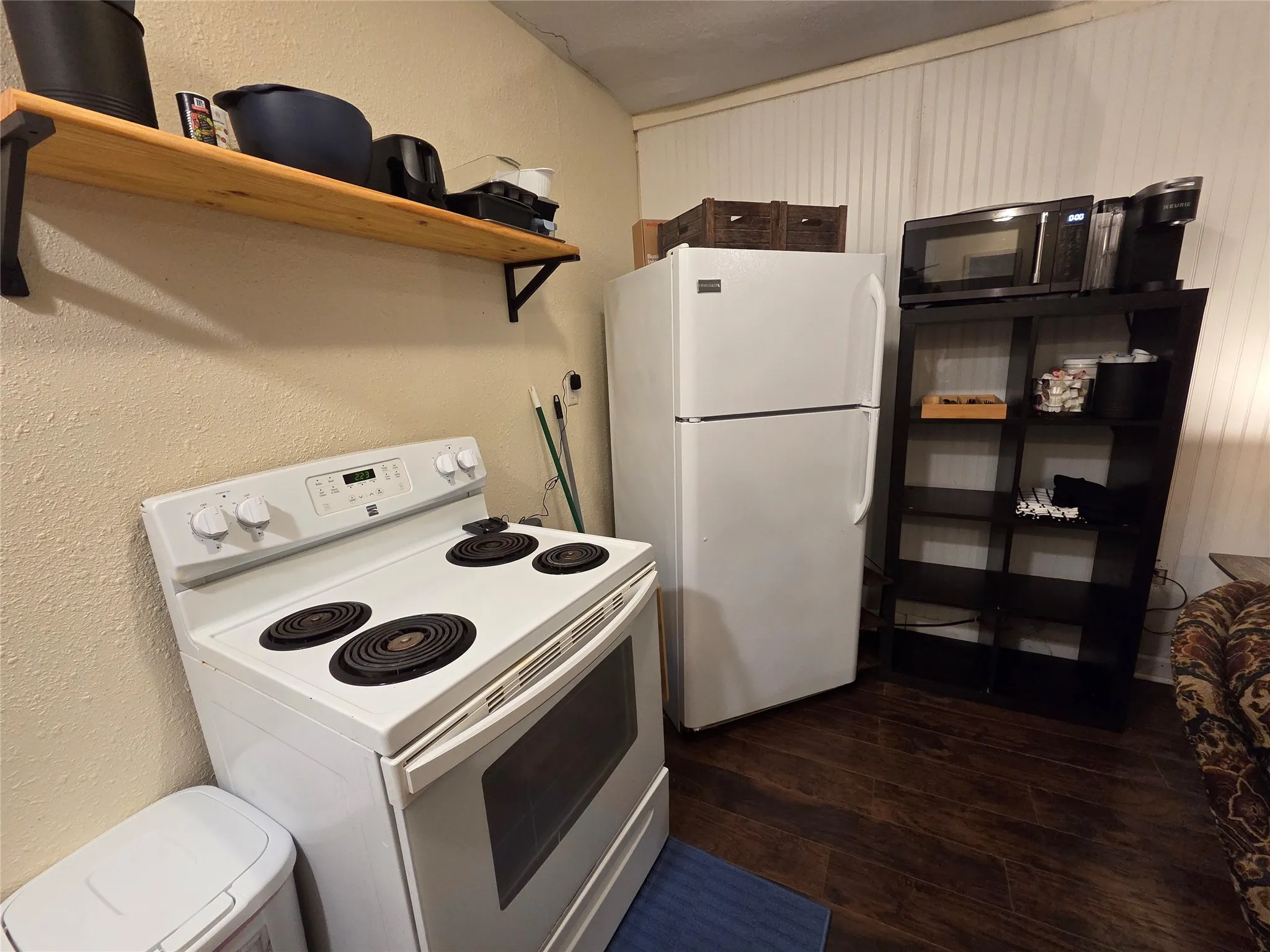 Full service kitchen including electric range, fridge, microwave, toaster, and Keurig. Kitchen is stocked with everything you need to cook and serve a meal.