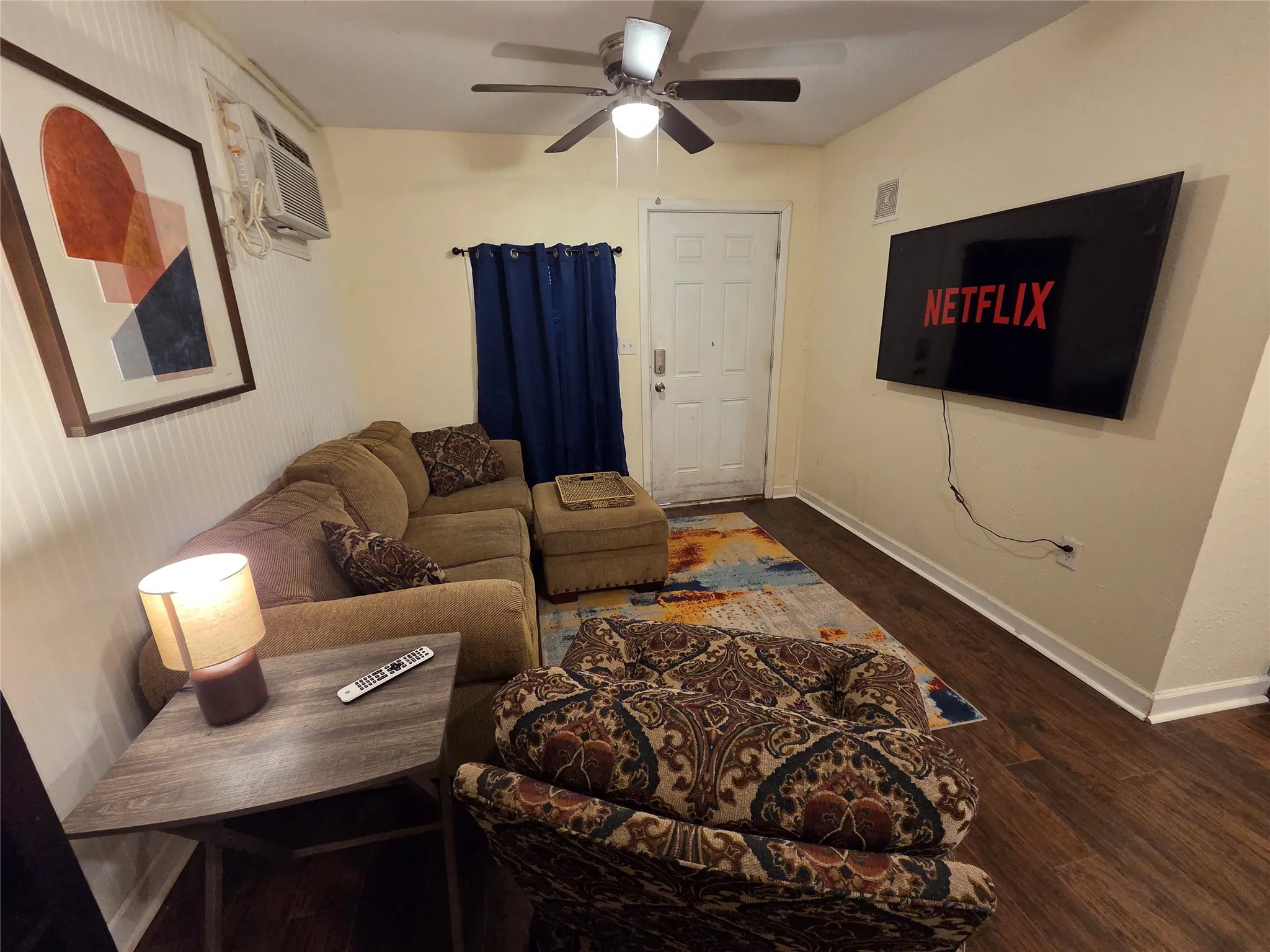 Large smart TV wall mounted and ready to enjoy. **PLEASE NOTE WE ARE WILLING TO REMOVE THE FURNISHINGS IF YOU ARE INTERESTED IN AN UNFURNISHED RENTAL AT A LOWER RATE**